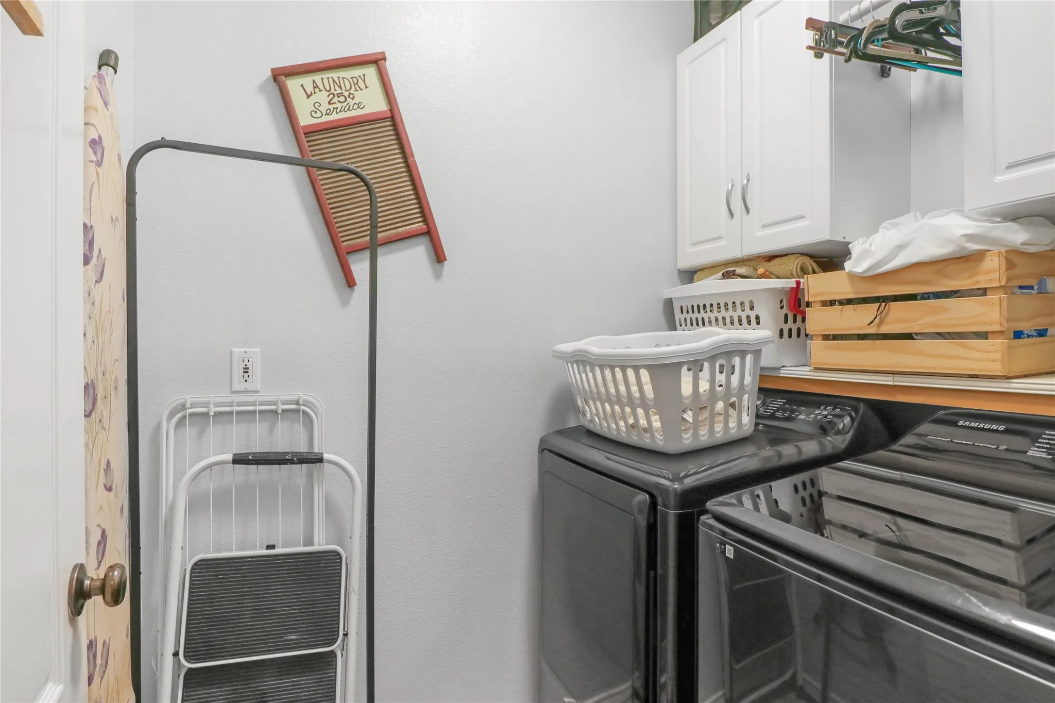 Laundry with shelf and cabinets.