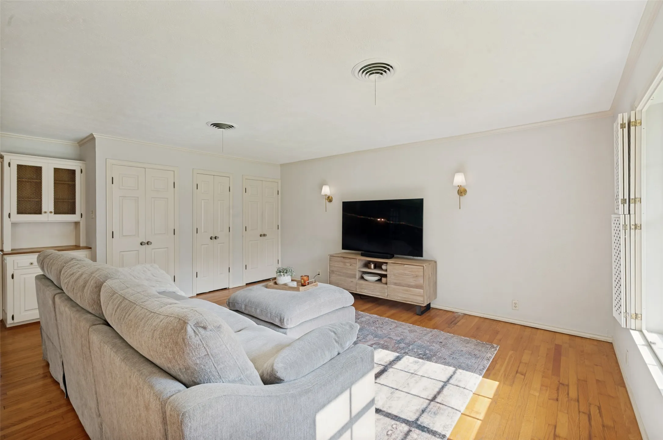 The living room features three storage closets in addition to a built-in hutch. Two of the closets house washer and dryer connections.  Another set us washer and dryer connections can be found in the garage.