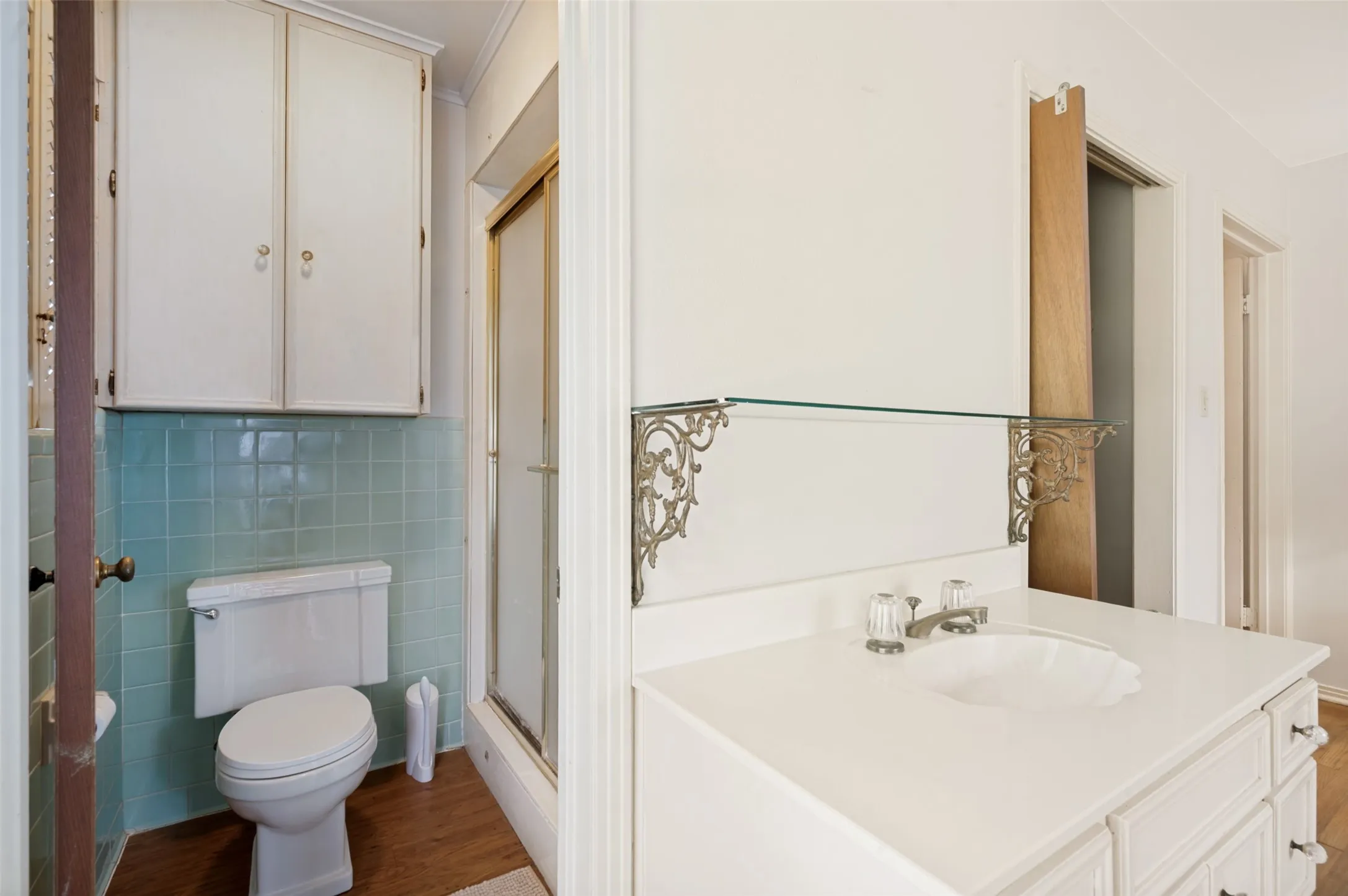 The bathroom boasts vintage tile and extra storage.