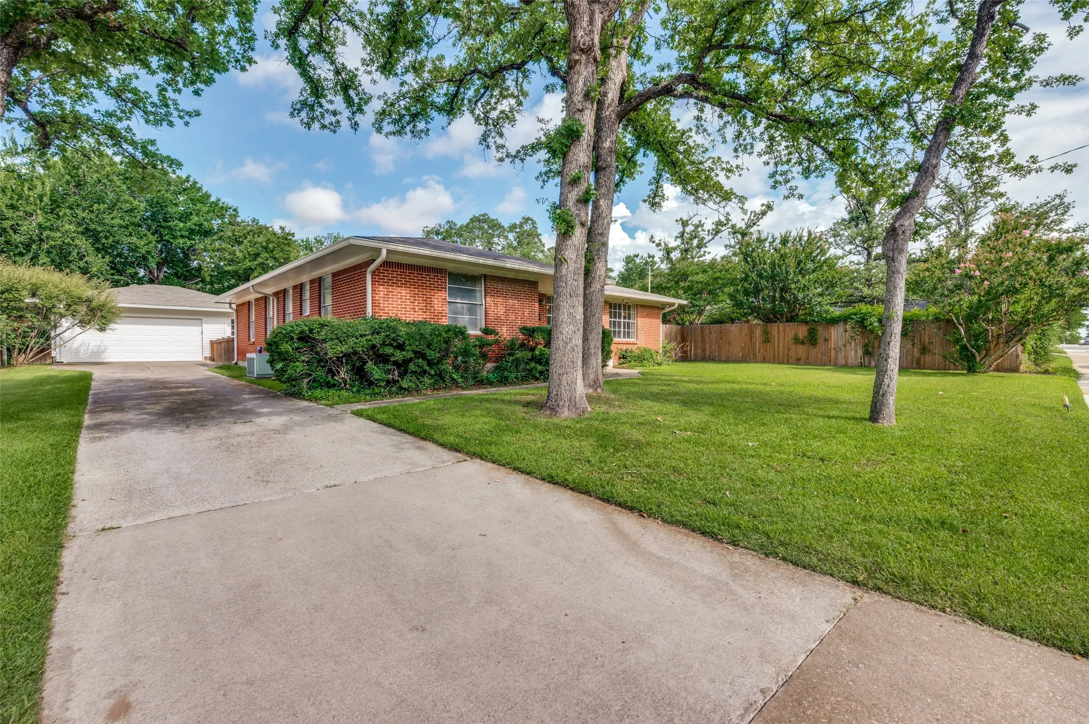 Traditional brick home on a manicured spacious lot with established landscaping.