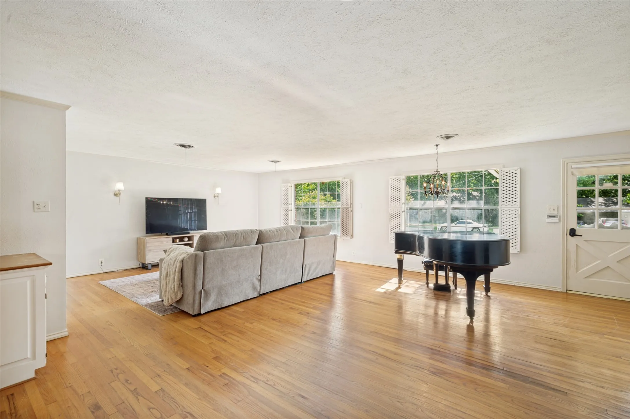 The large open living area provides a versatile space for dining and entertaining.