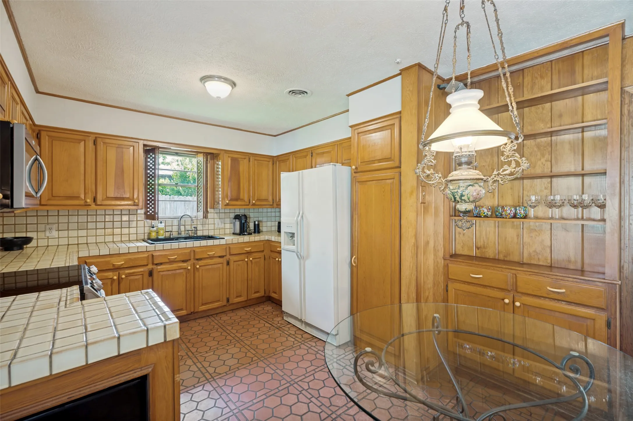 Spacious countertops and cabinets, along with a large pantry and display hutch make this kitchen a cook's dream.
