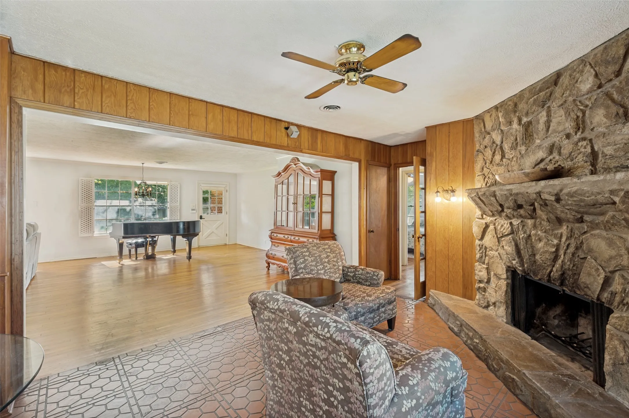 View of the living room and front door from the sitting room.