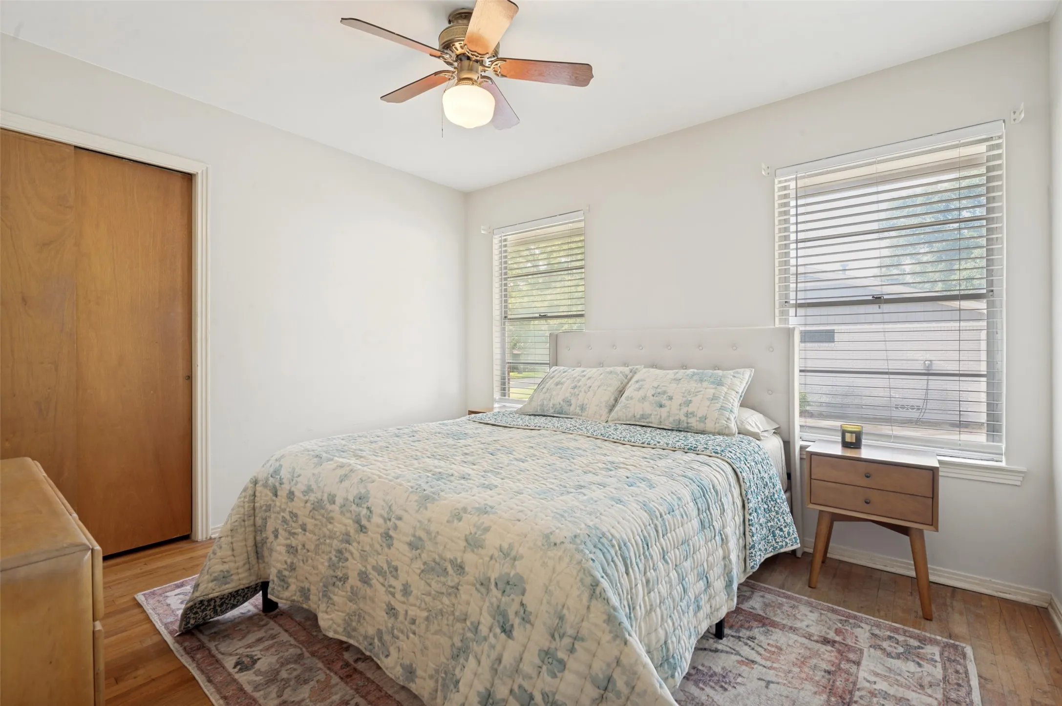 Secondary bedrooms feature hardwood floors, windows and a large closet.