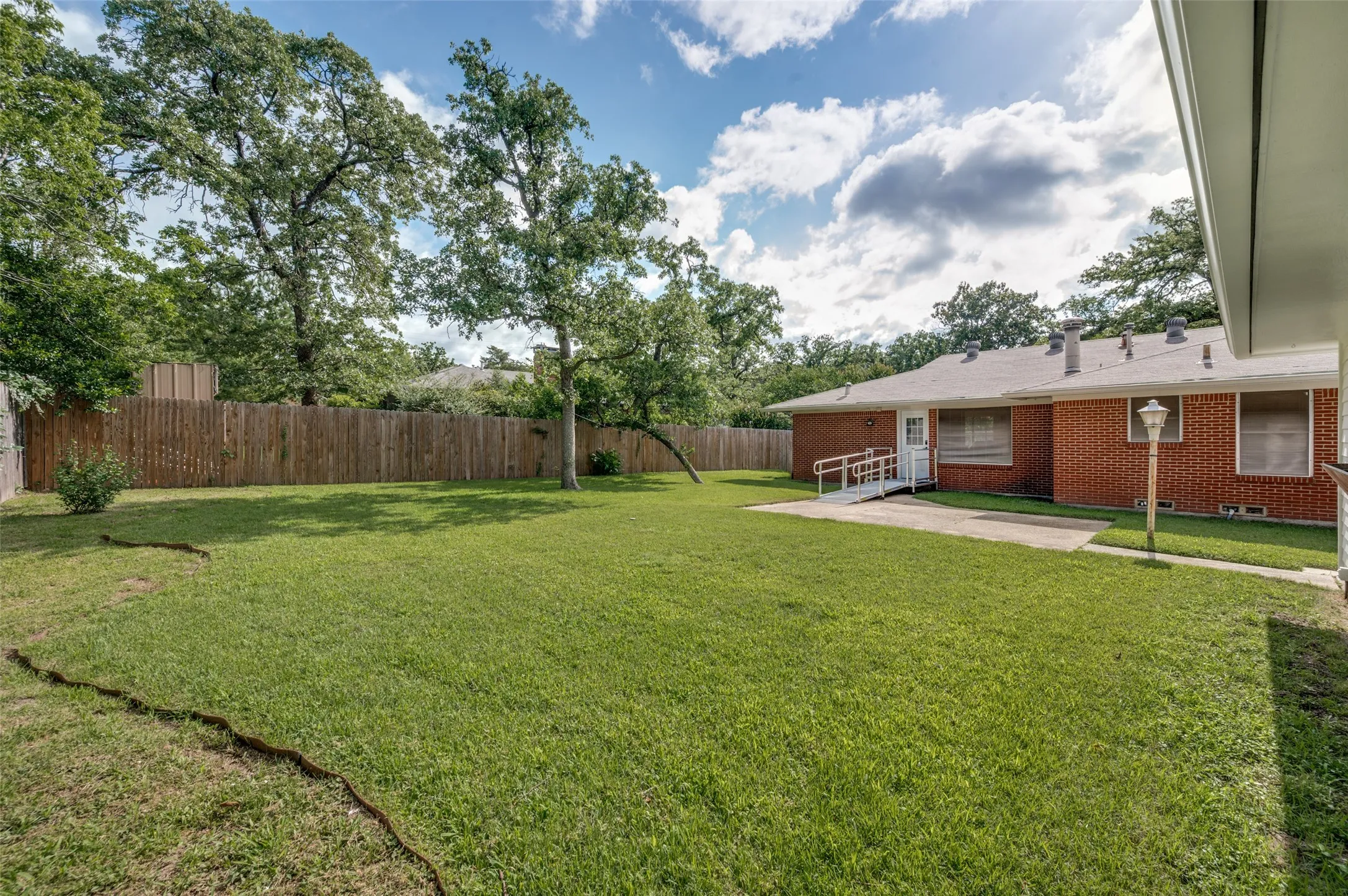 This massive backyard is ready for your outdoor entertaining and gardening.