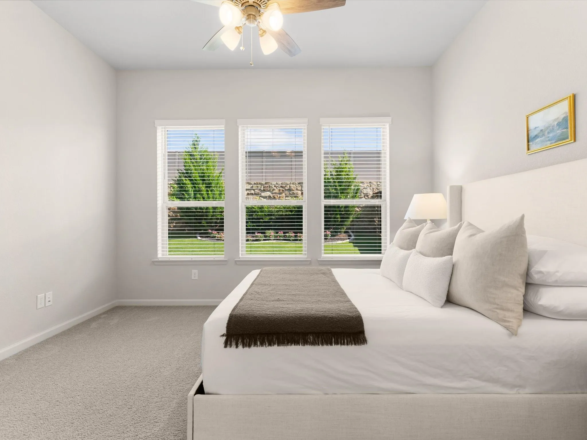 Primary bedroom offering comfort, natural light, and views of the backyard.