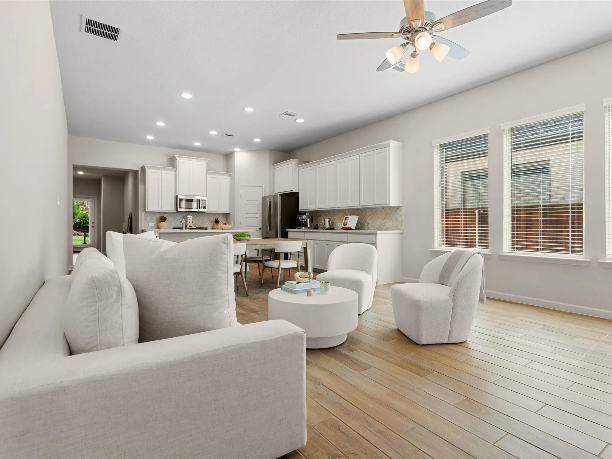 Open-concept floor plan connecting the kitchen, dining, and living spaces.