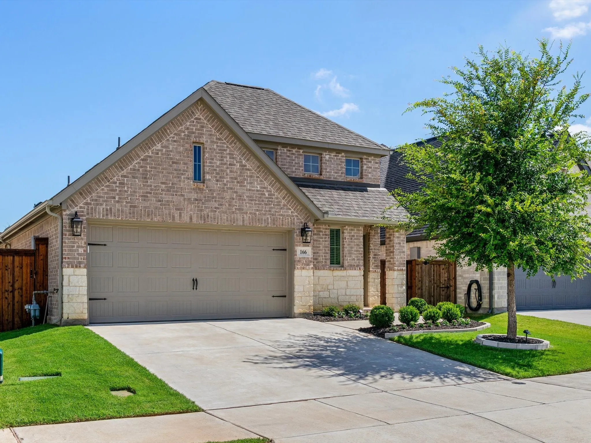 Front elevation of 166 Palo Duro Bend in Rhome, Texas, featuring attractive curb appeal and a well-maintained exterior.
