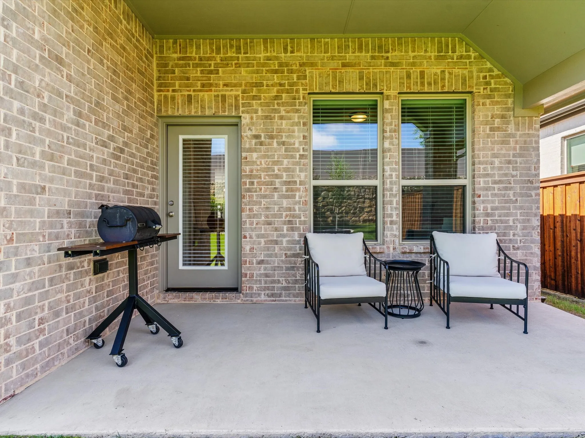 Covered patio overlooking the backyard, ideal for outdoor relaxation.