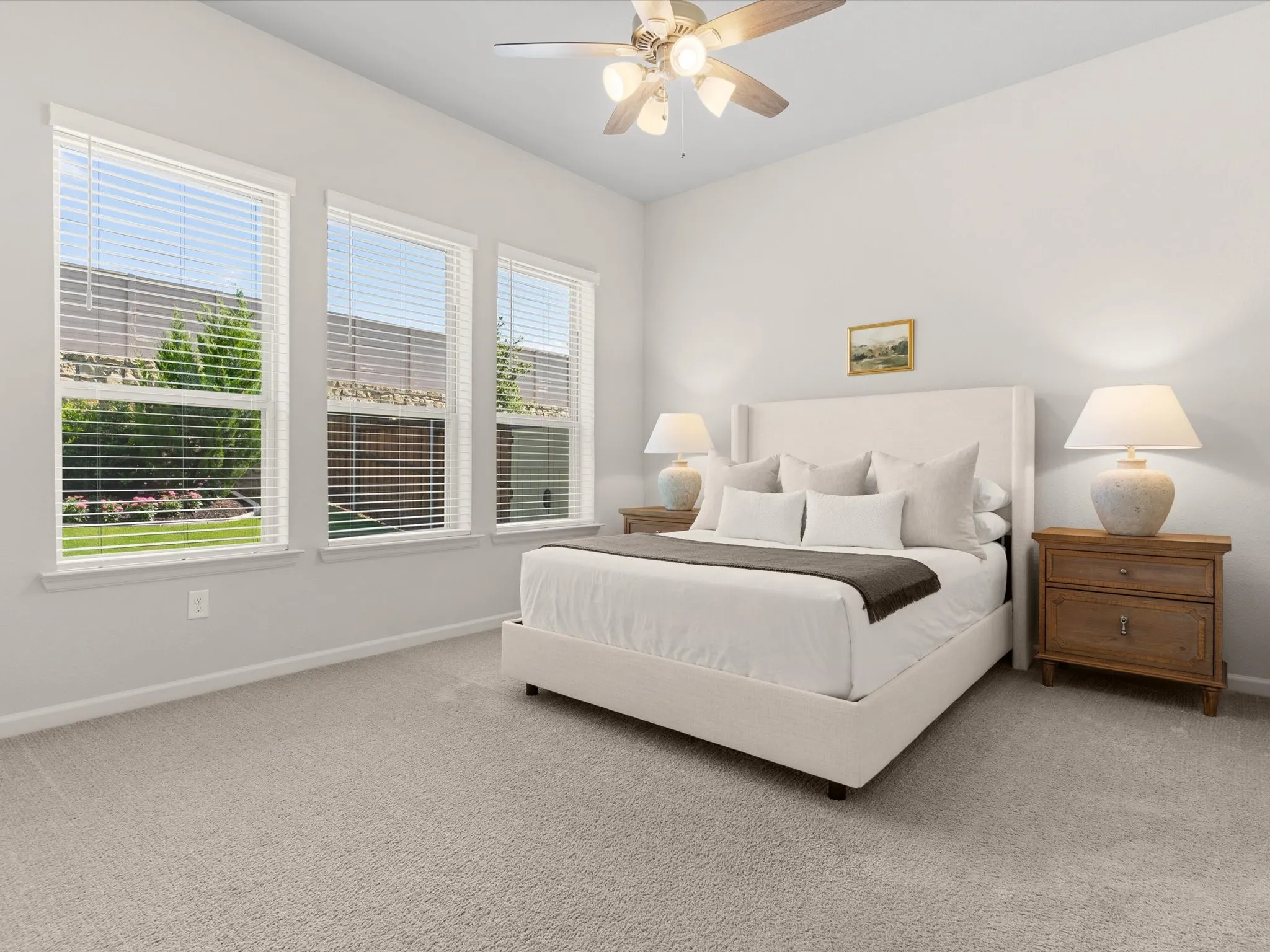 Primary bedroom offering comfort, natural light, and views of the backyard.