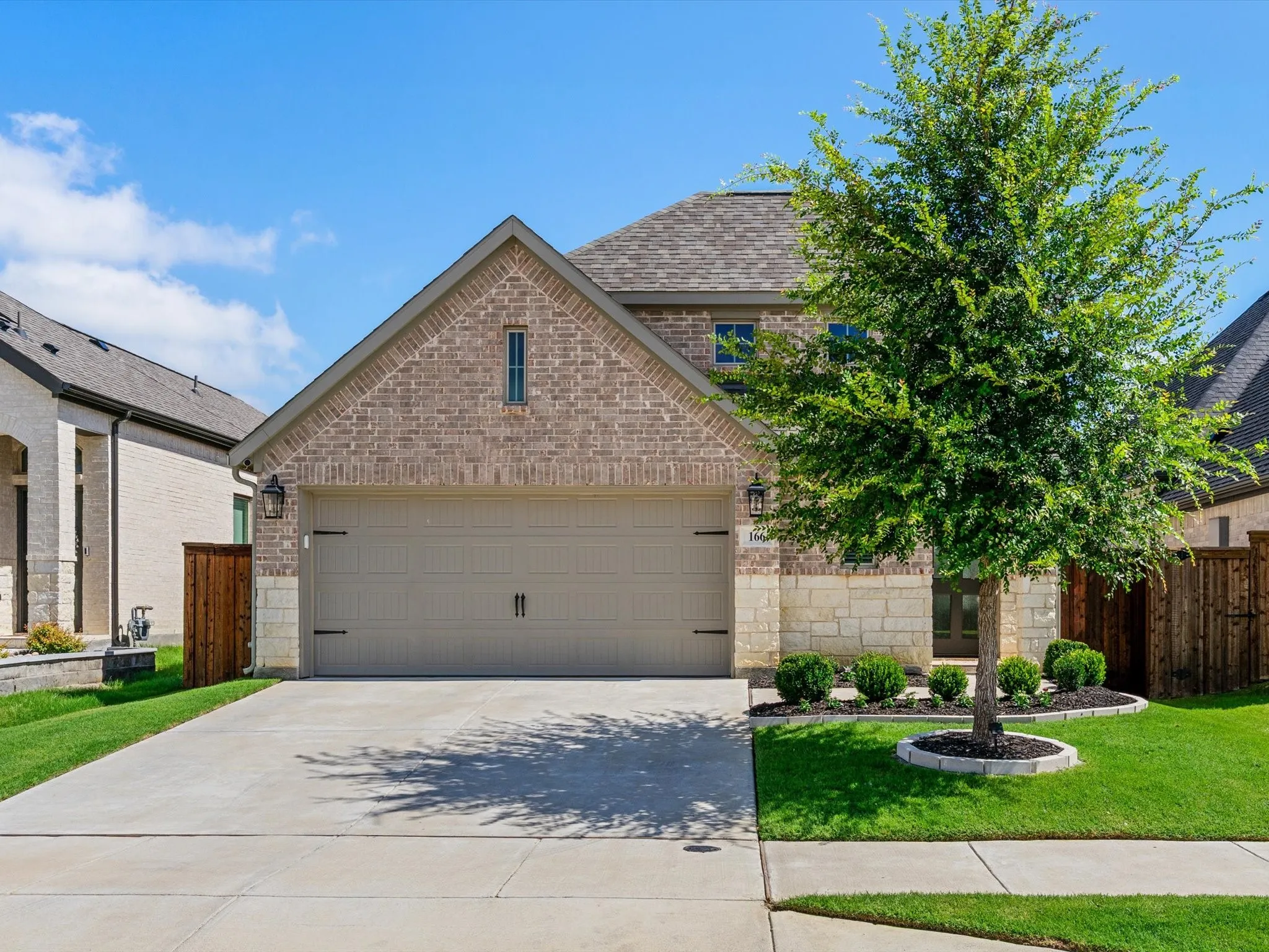 Front elevation of 166 Palo Duro Bend in Rhome, Texas, featuring attractive curb appeal and a well-maintained exterior.