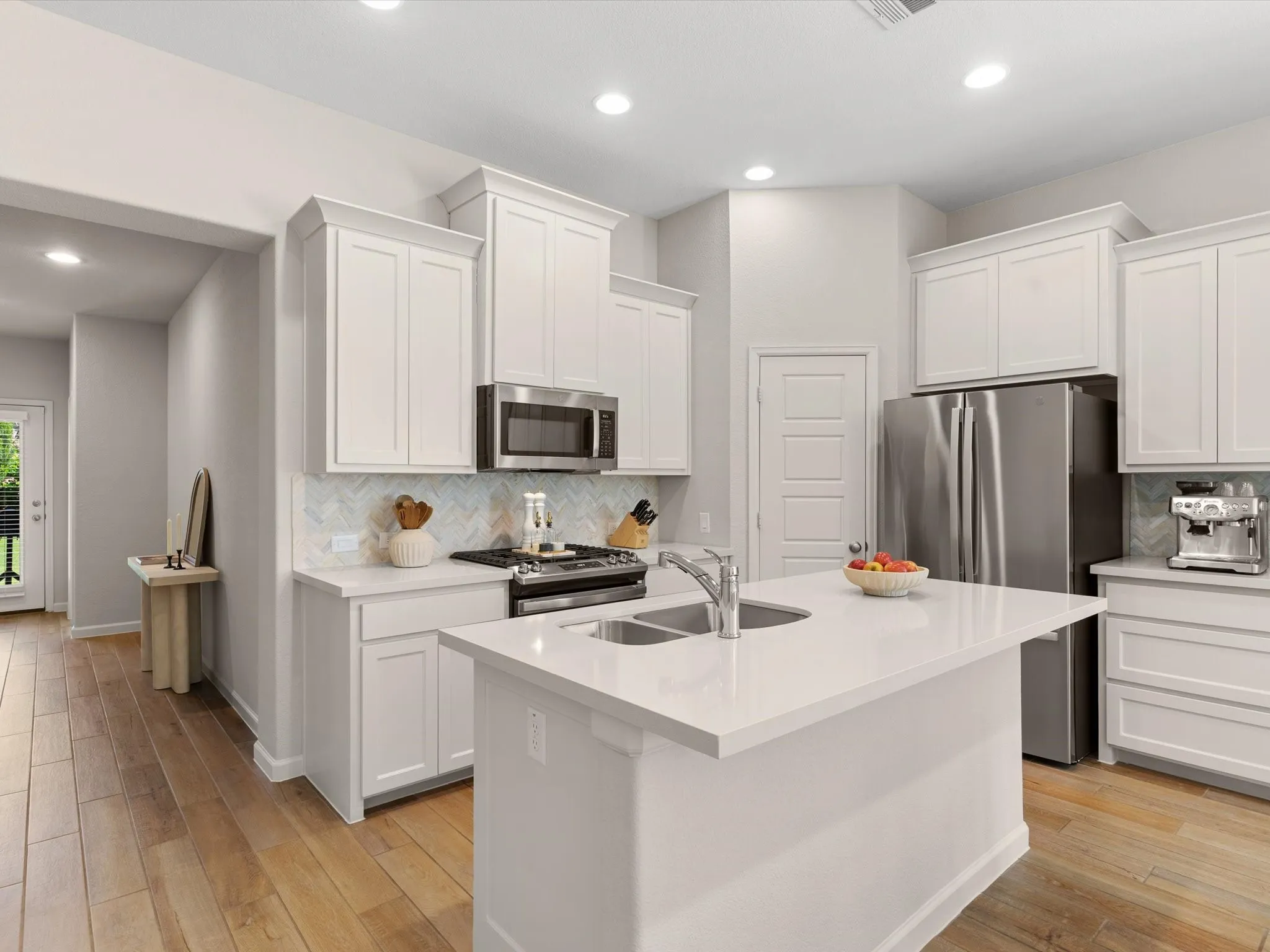 Modern kitchen featuring granite countertops, stainless steel appliances, ample cabinetry, and a center island.