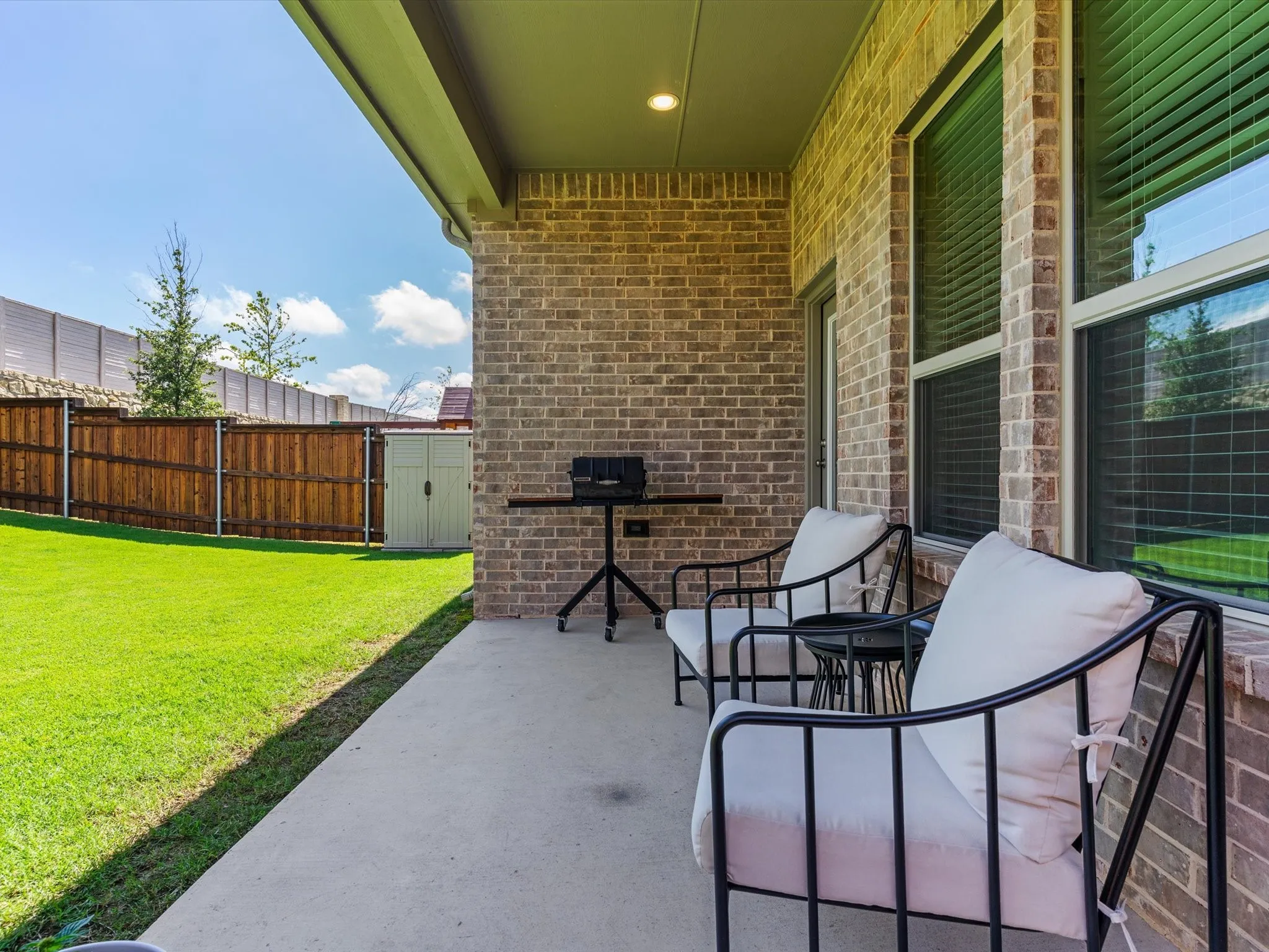 Covered patio overlooking the backyard, ideal for outdoor relaxation.