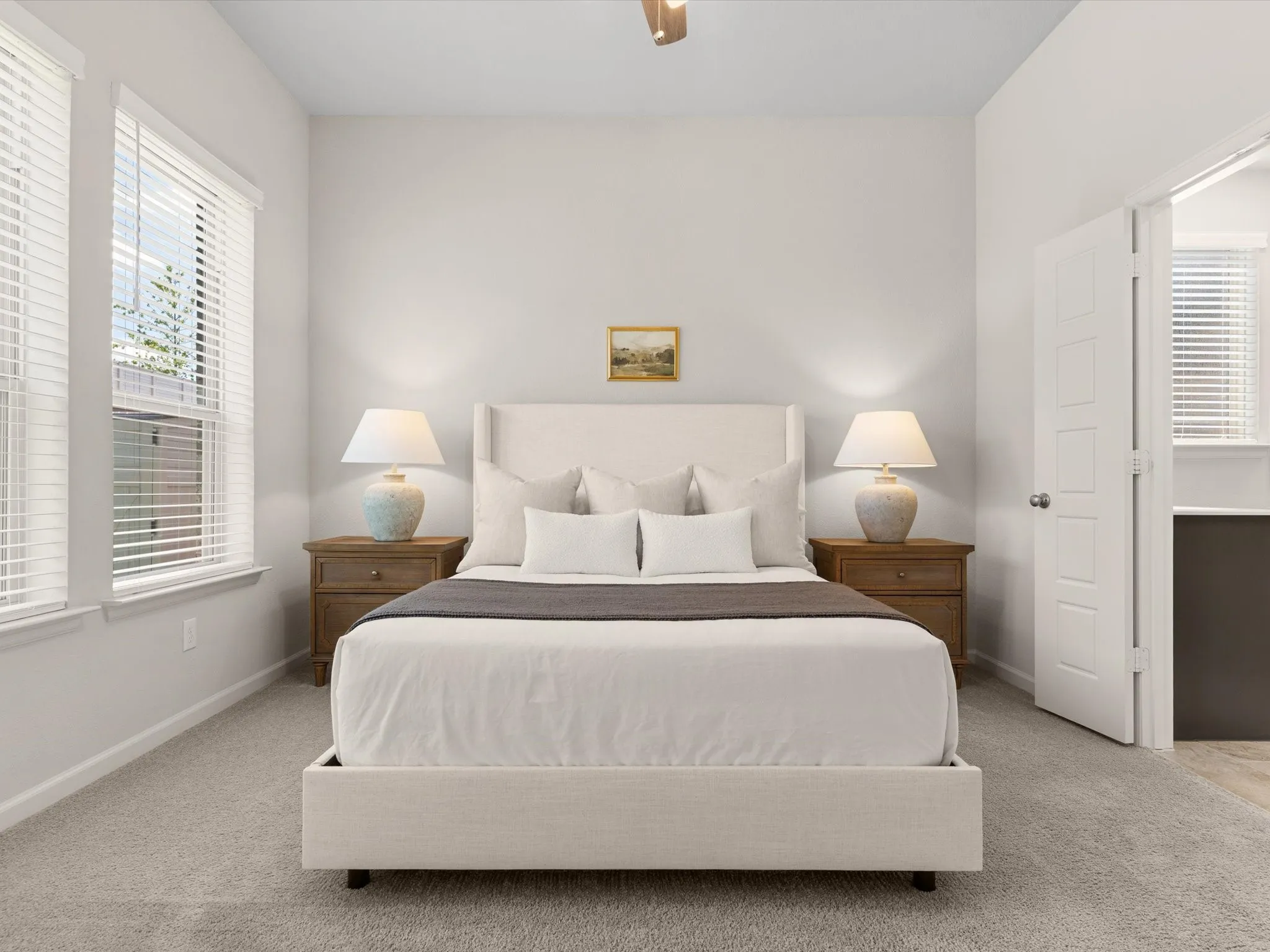 Primary bedroom offering comfort, natural light, and views of the backyard.