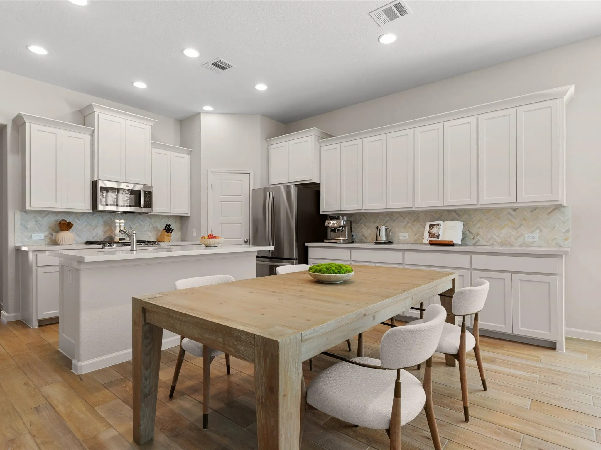 Modern kitchen featuring granite countertops, stainless steel appliances, ample cabinetry, and a center island.