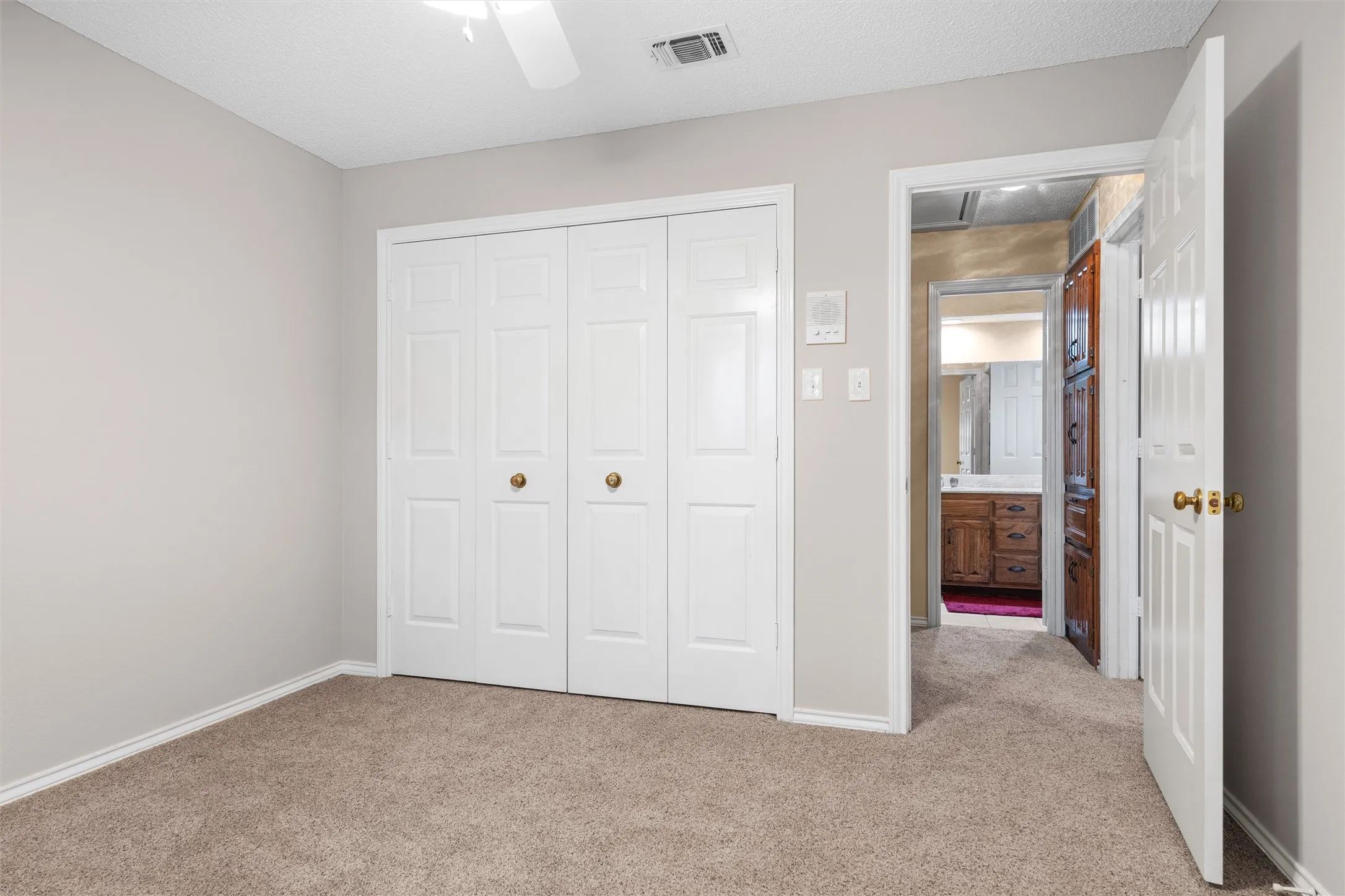 Neutral-toned walls complement plush carpet flooring