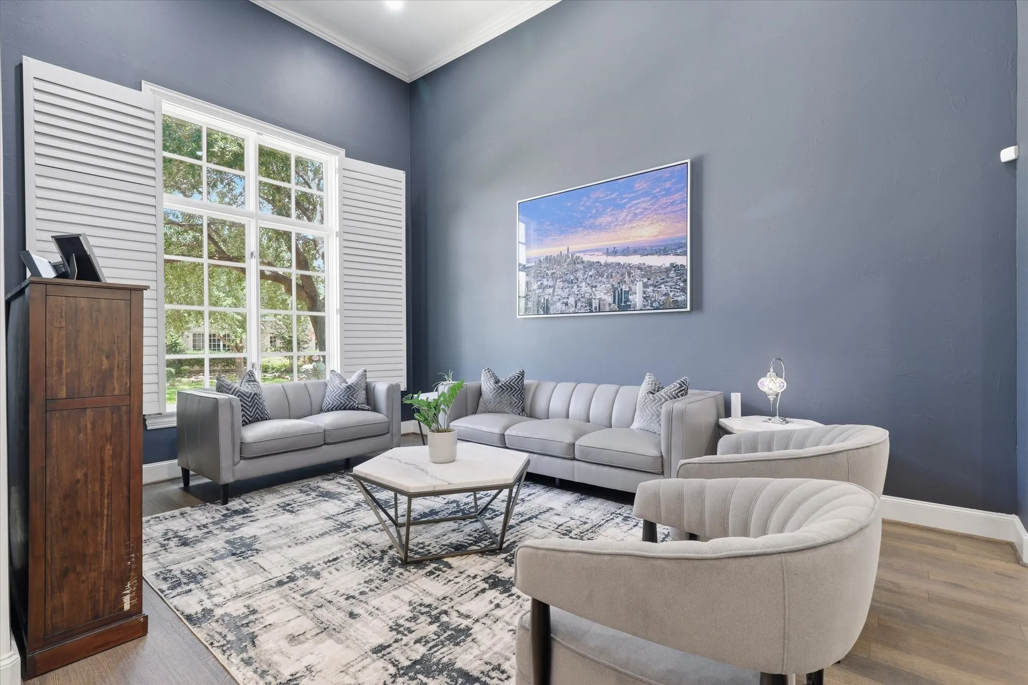 The Living Room with Plantation Shutters and wood floors is nicely sized.
