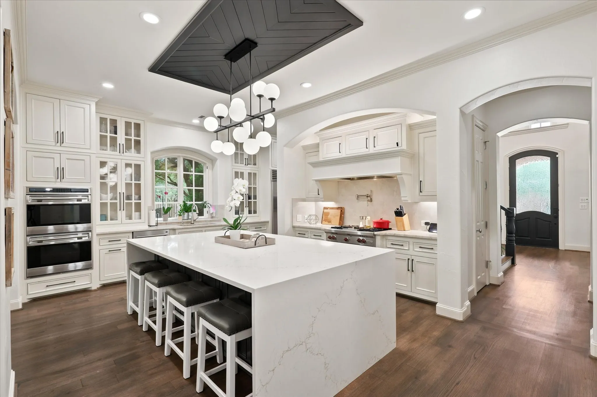 Featuring beautiful cabinetry, Wolf Appliances, a breakfast bar, pot filler and built in SubZero refrigerator, this Kitchen Wows!