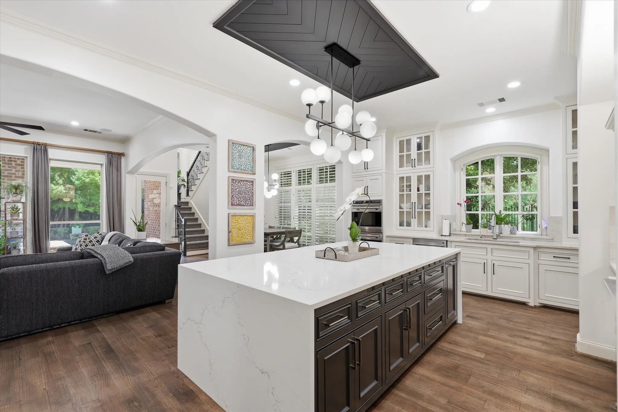 The Kitchen is updated with a large center island with storage, waterfall edge and updated lighting.