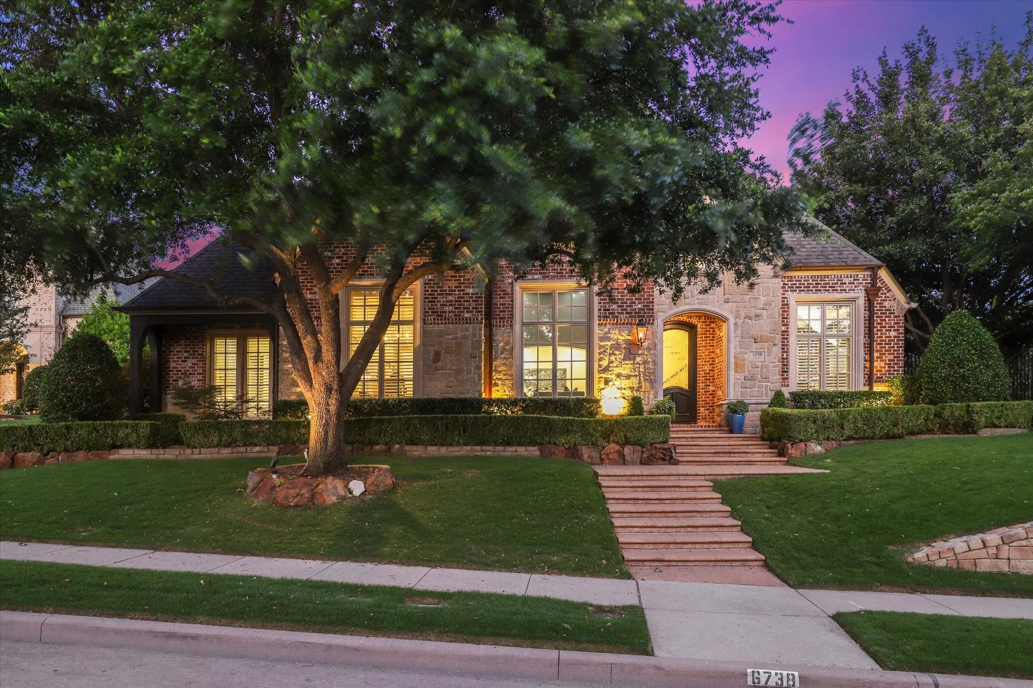 Welcome to 6738 Reims Court. This stunning brick and rock home sits on a slightly elevated corner lot offering striking drive up appeal.
