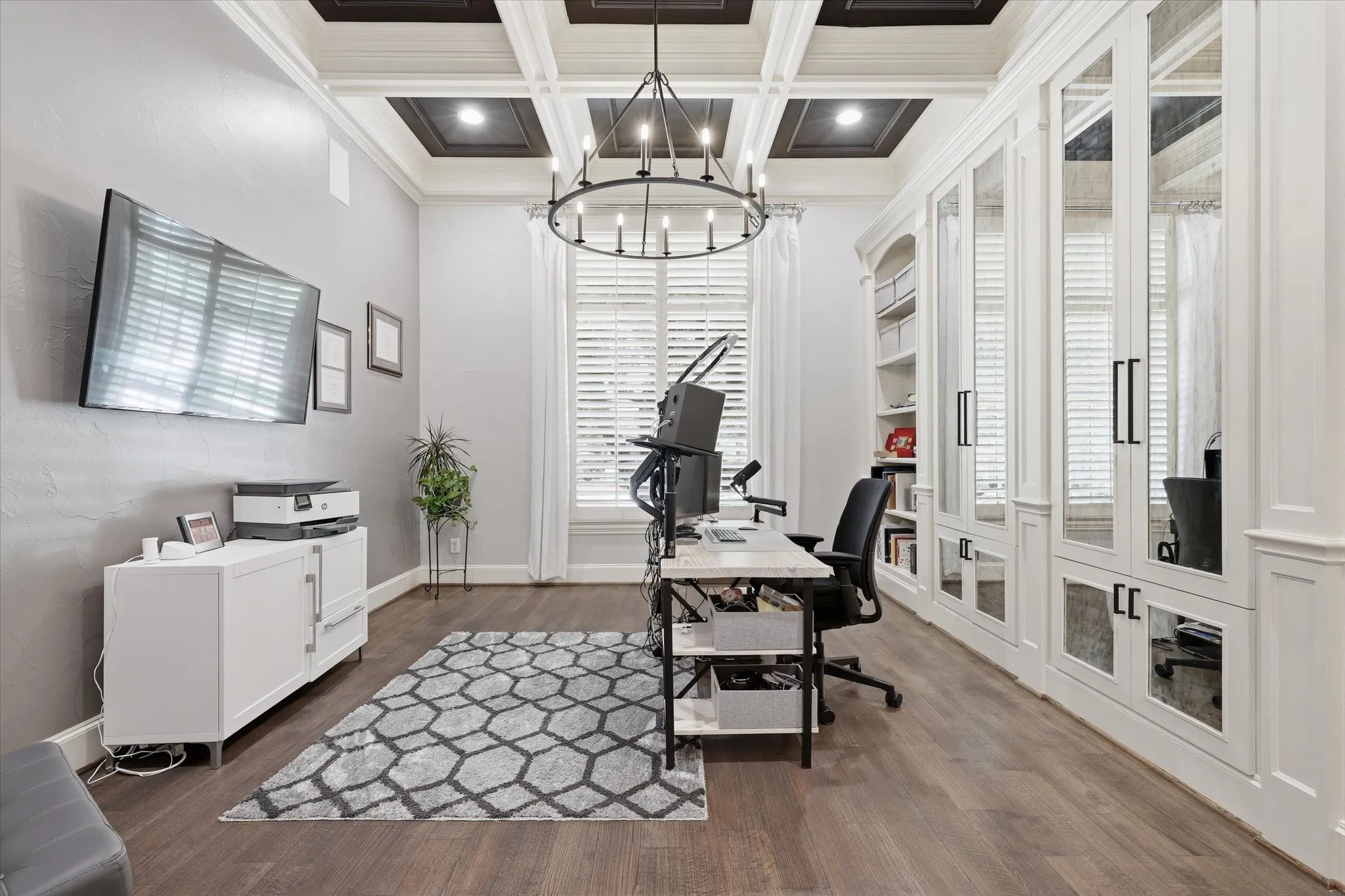 The office offers custom built ins with doors, Plantation Shutters and hard wood flooring.