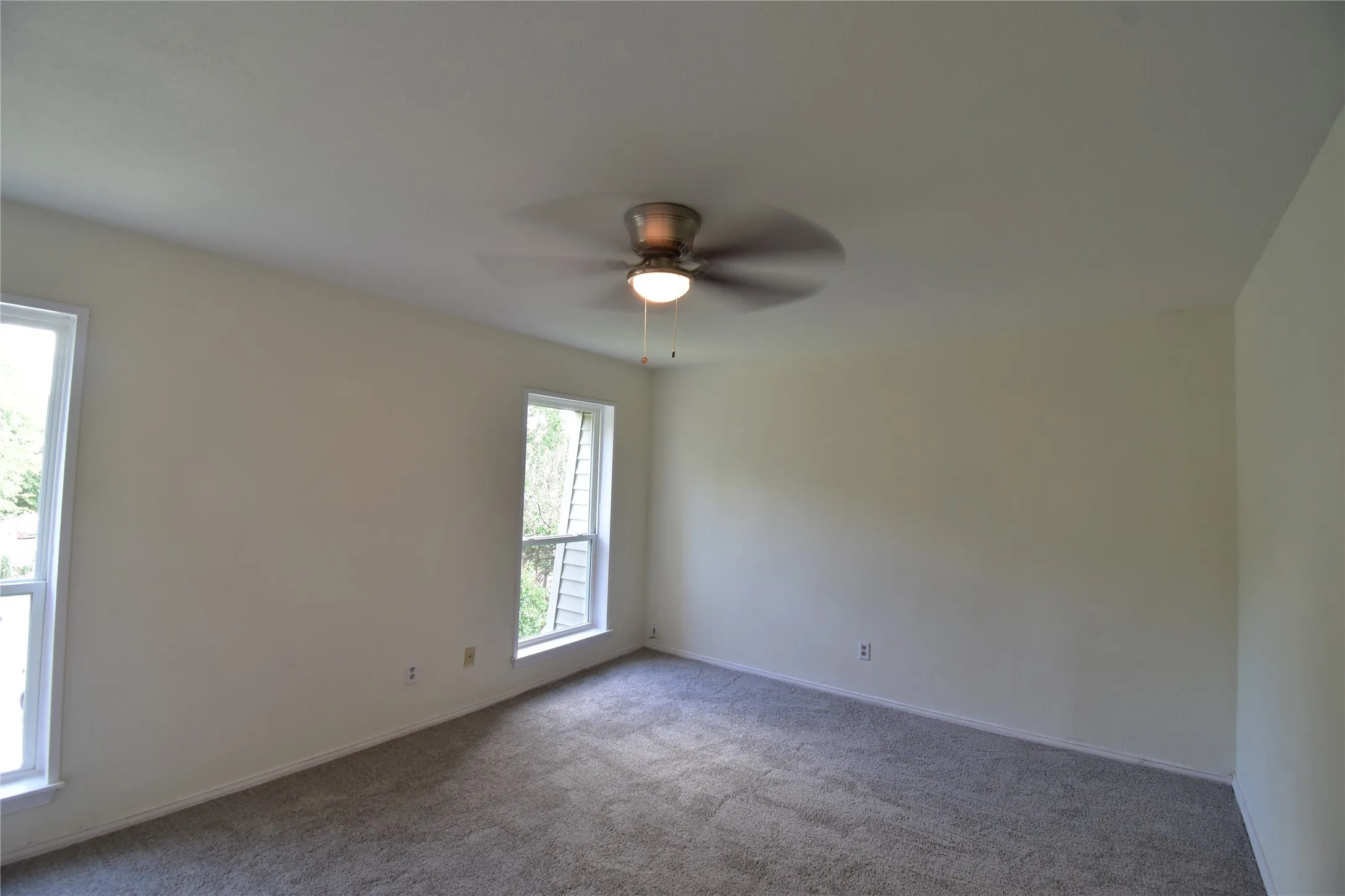 Large master bedroom with new windows, new ceiling fan and new carpel