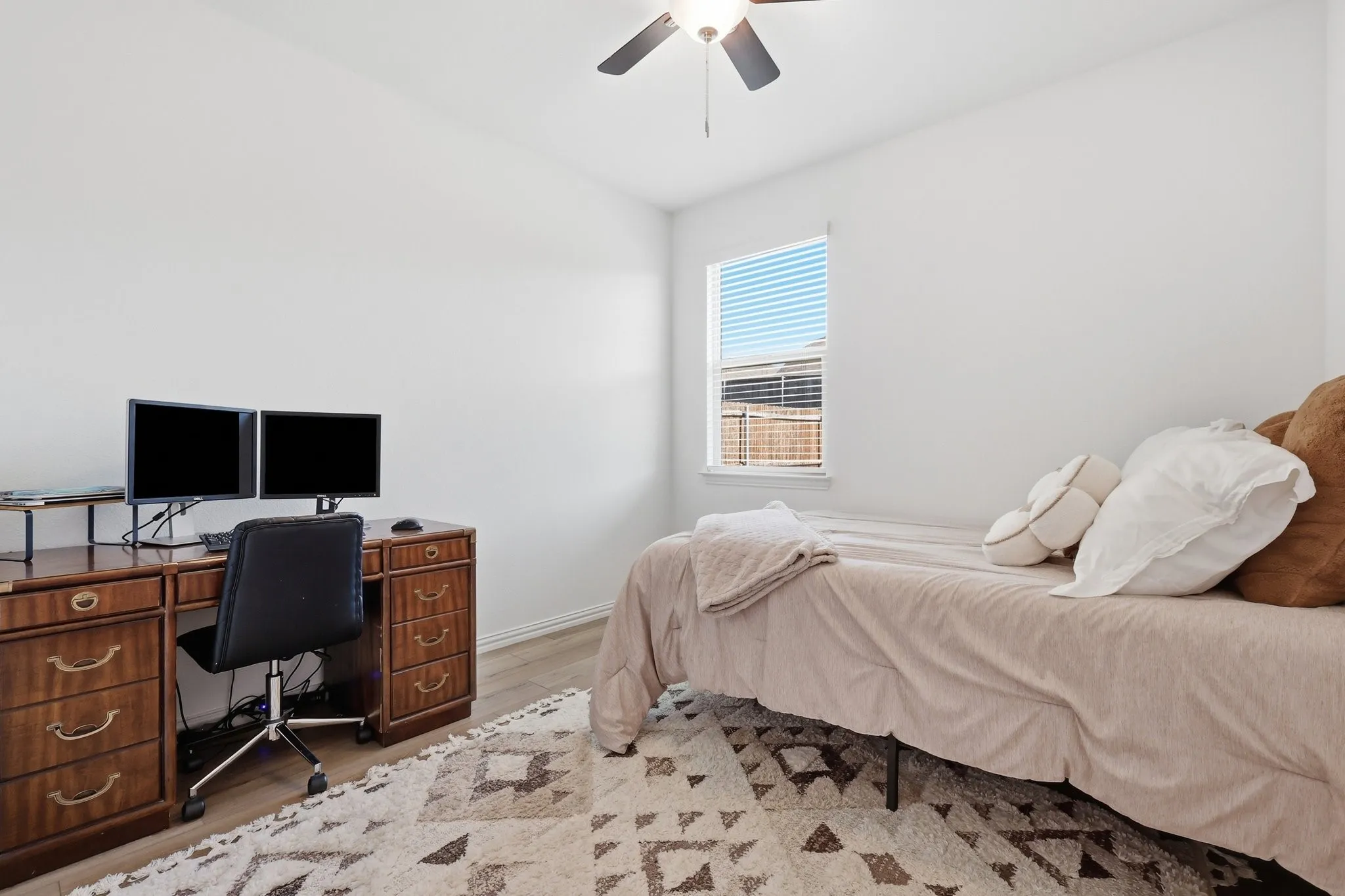 Bright room featuring light wood-finish flooring and white walls