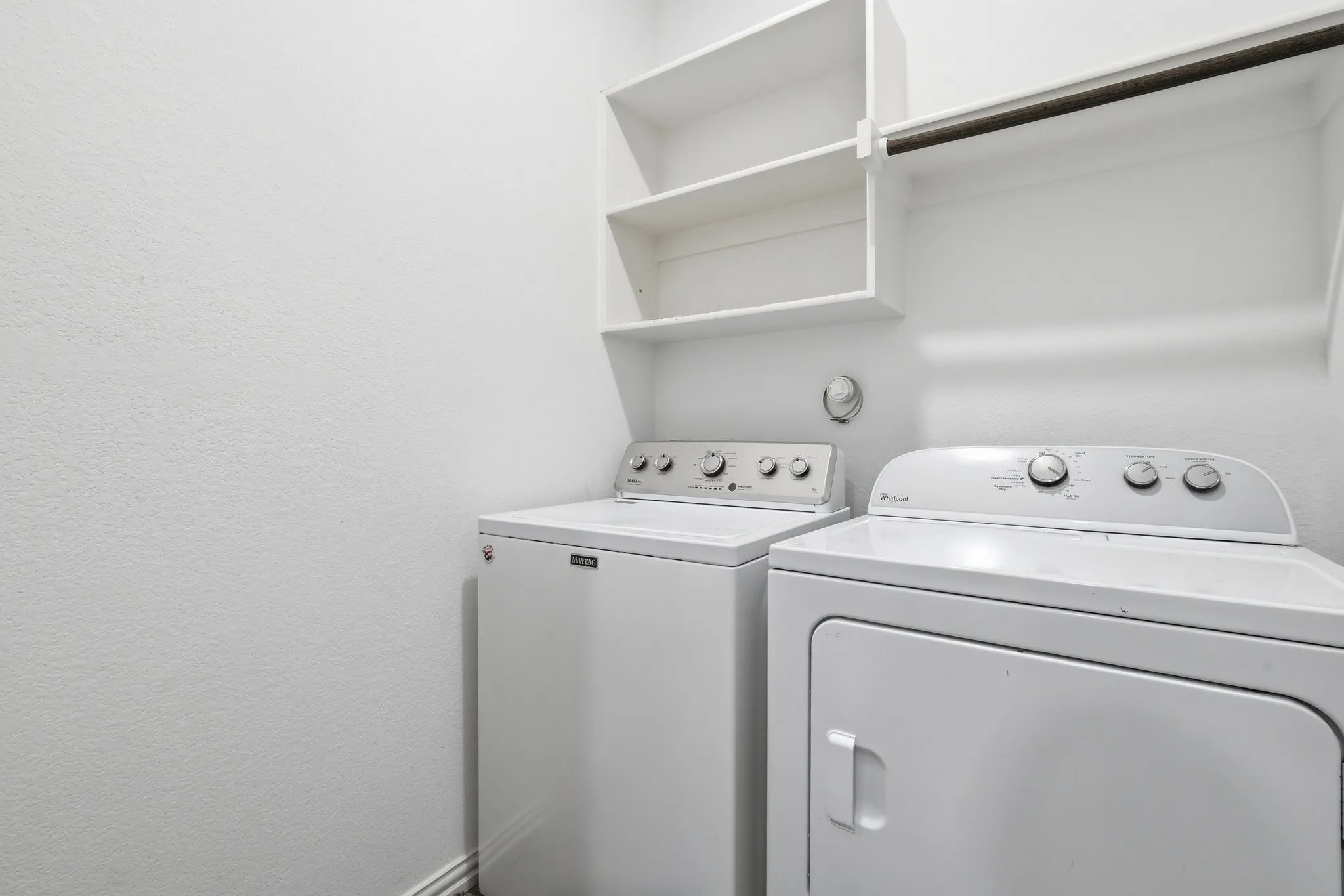 Dedicated laundry area featuring a white washer and dryer set