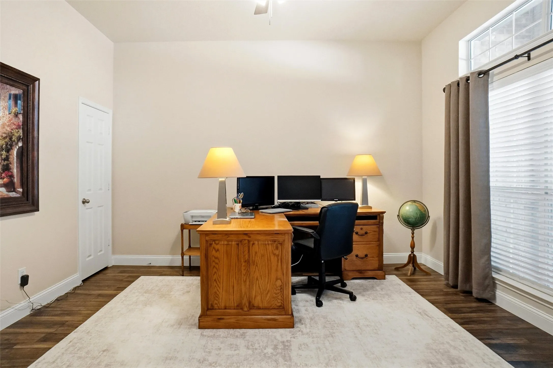 Spacious room featuring wood-finish flooring and a neutral color palette