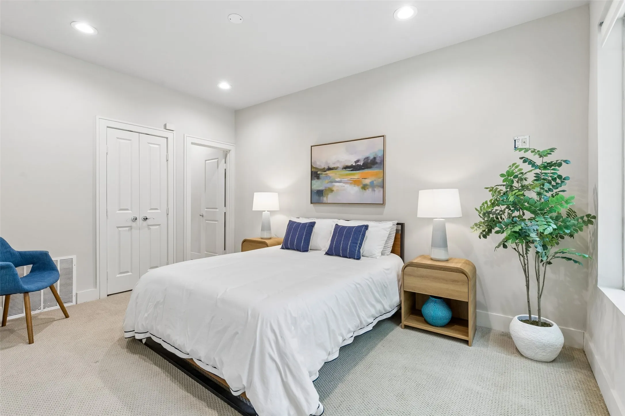 Carpeted room featuring recessed lighting, a window, and two paneled doors with chrome hardware