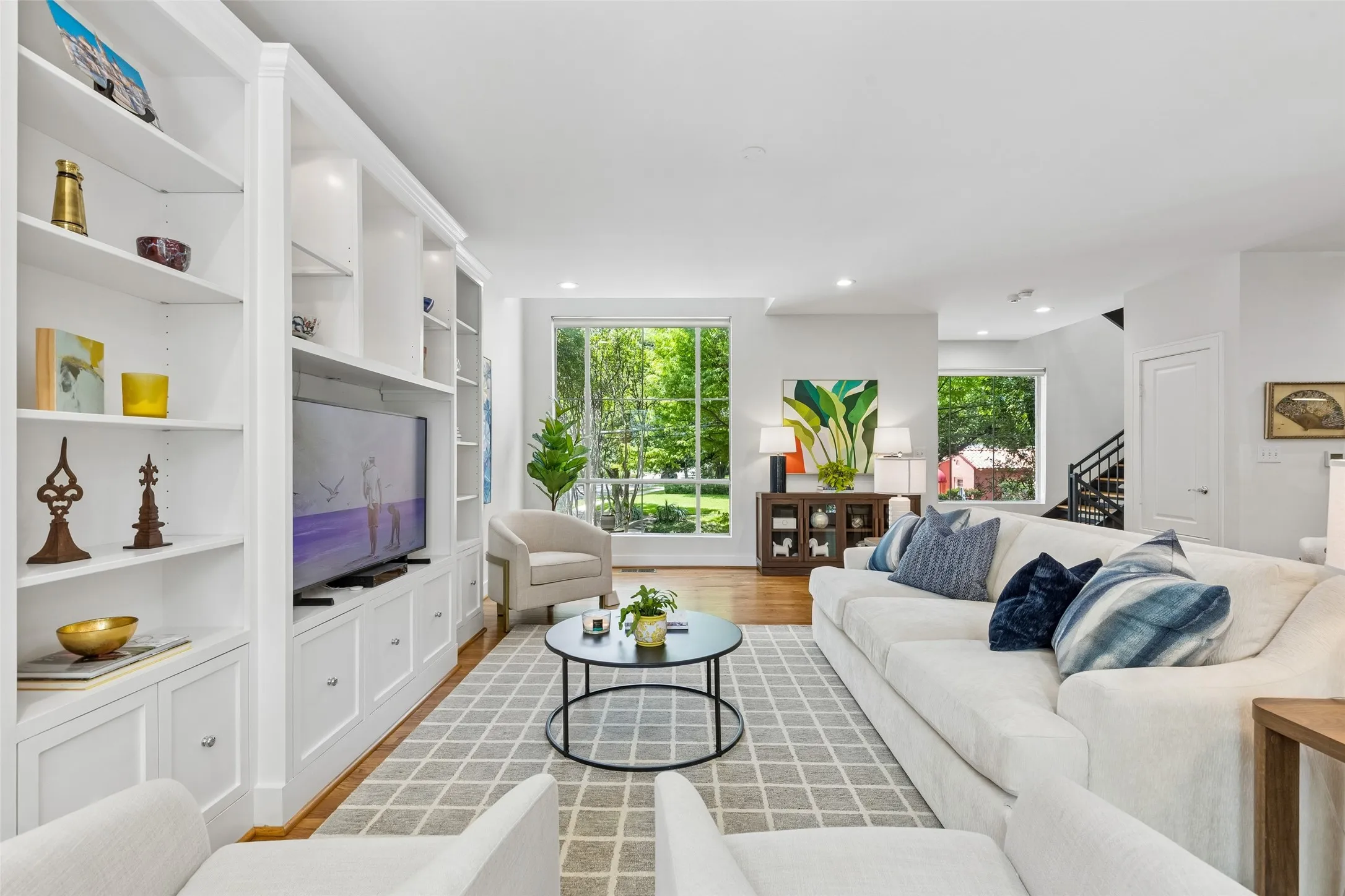 Living room featuring wood-finish flooring and a large area rug
