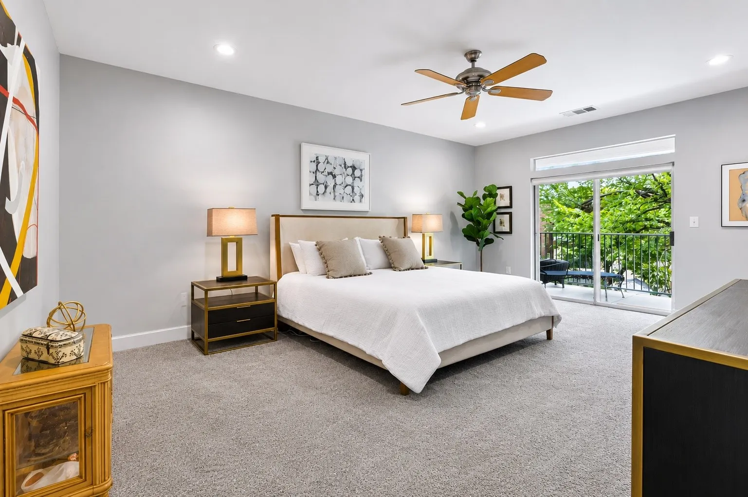 Expansive bedroom featuring light gray walls, plush gray carpeting, recessed lighting, and a ceiling fan