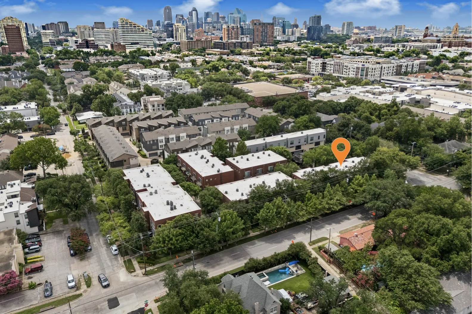 Aerial perspective showcasing a dense urban setting with a prominent city skyline in the background