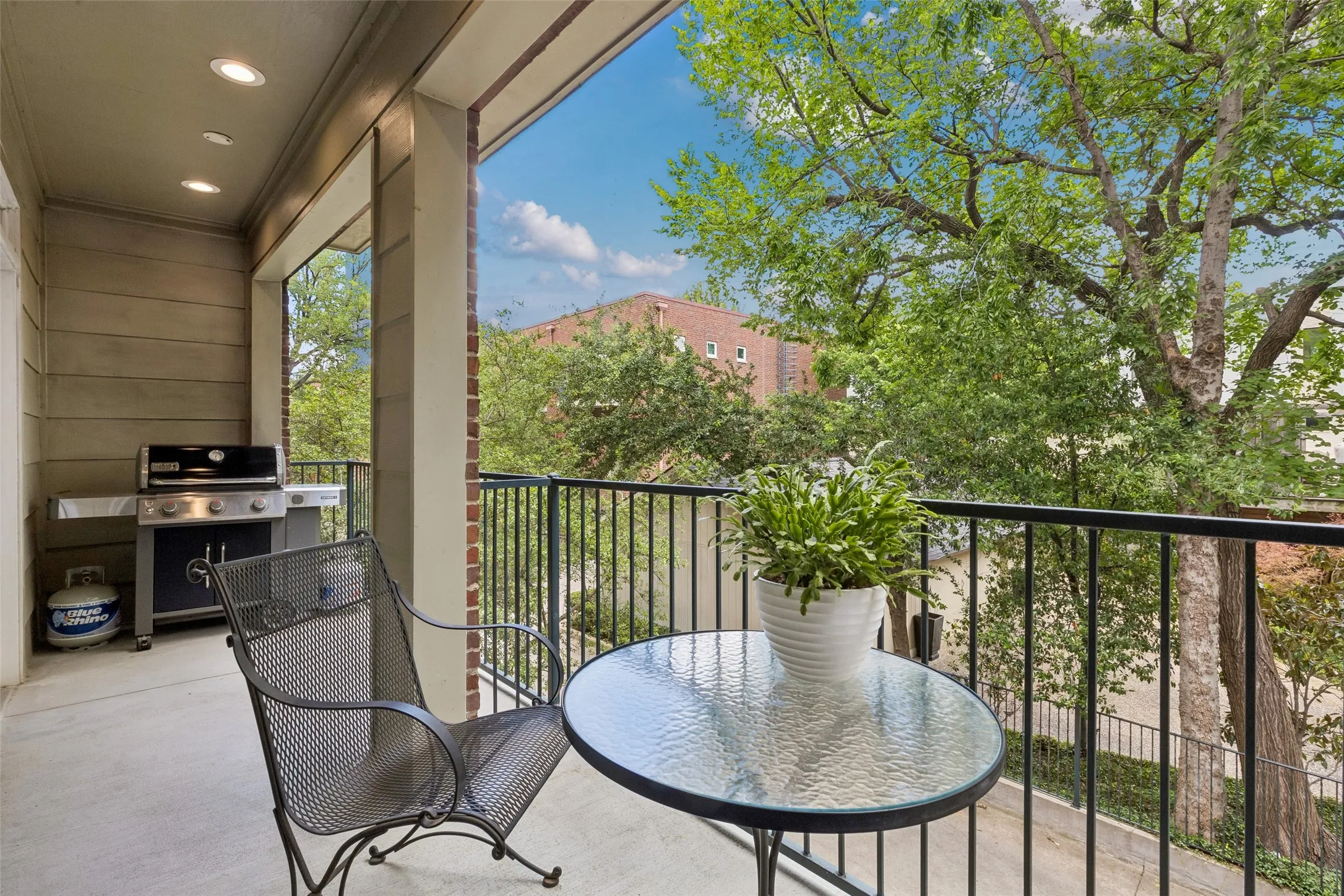 Spacious balcony featuring recessed lighting and a stone-style exterior wall