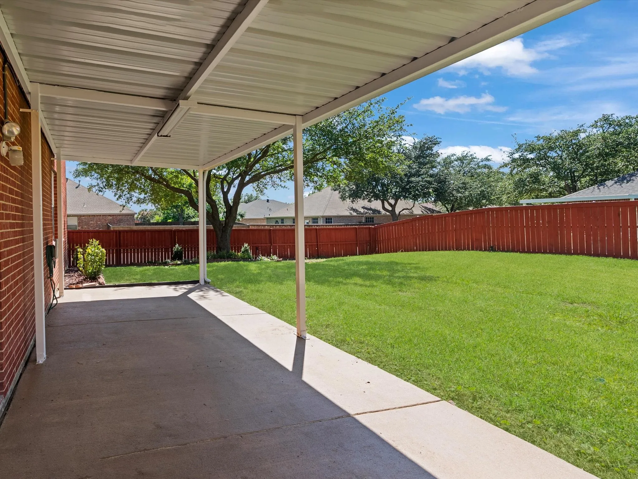 Covered patio featuring a concrete slab and a metal roof structure