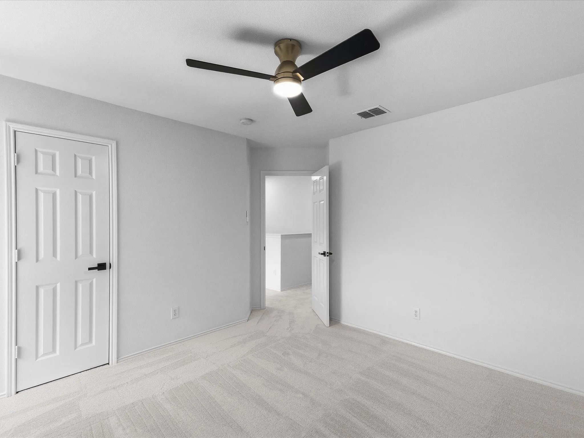 Room featuring light-colored wall paint, white trim, and light-toned carpet flooring