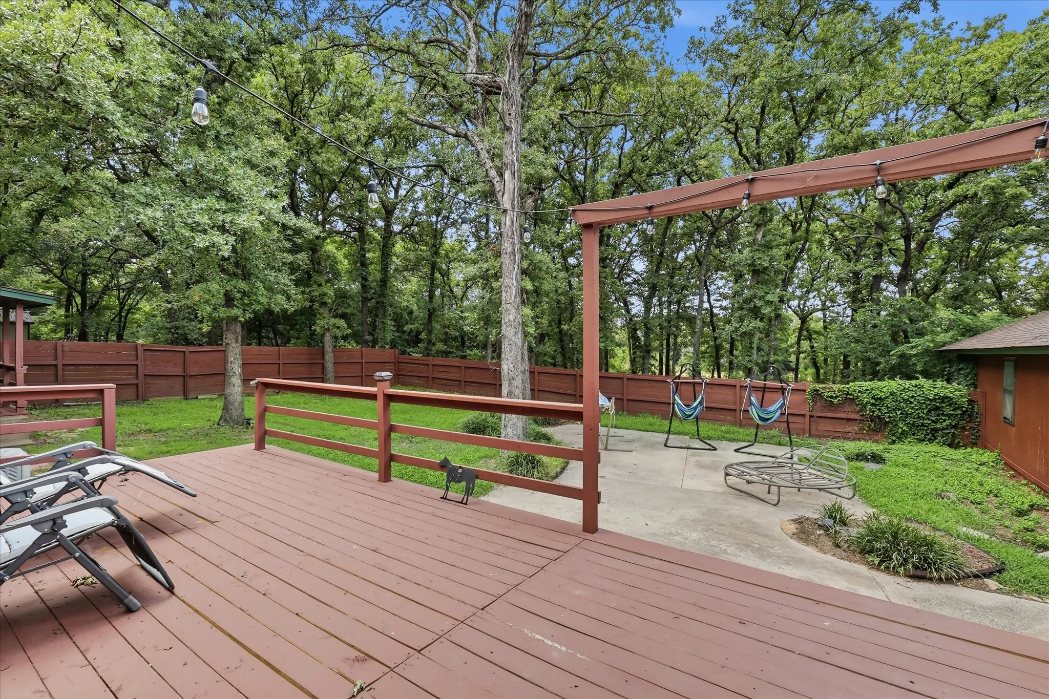 Expansive wood deck with a red-stained finish and matching railings