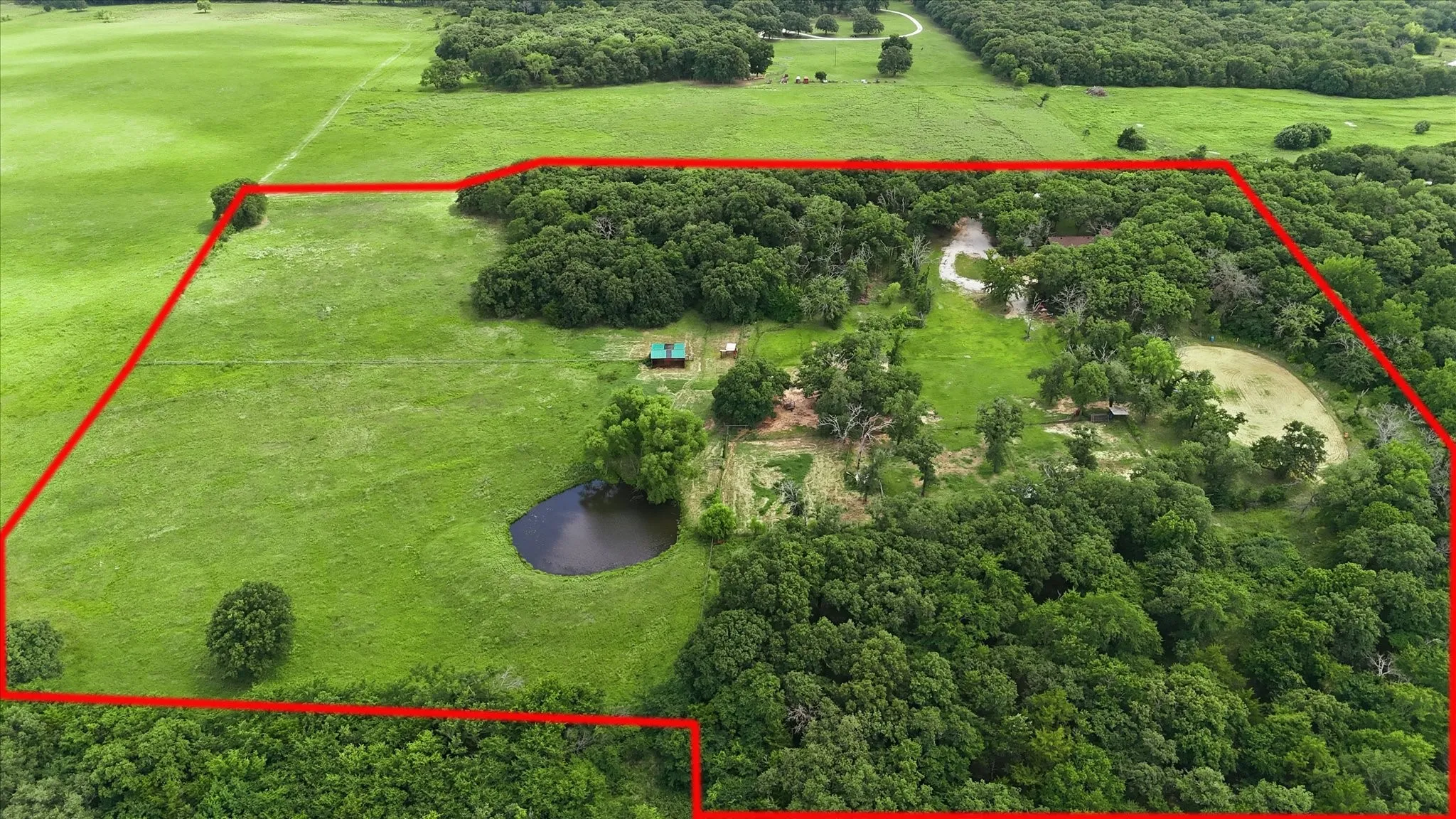 Expansive rural acreage featuring significant tree coverage and open pasture areas