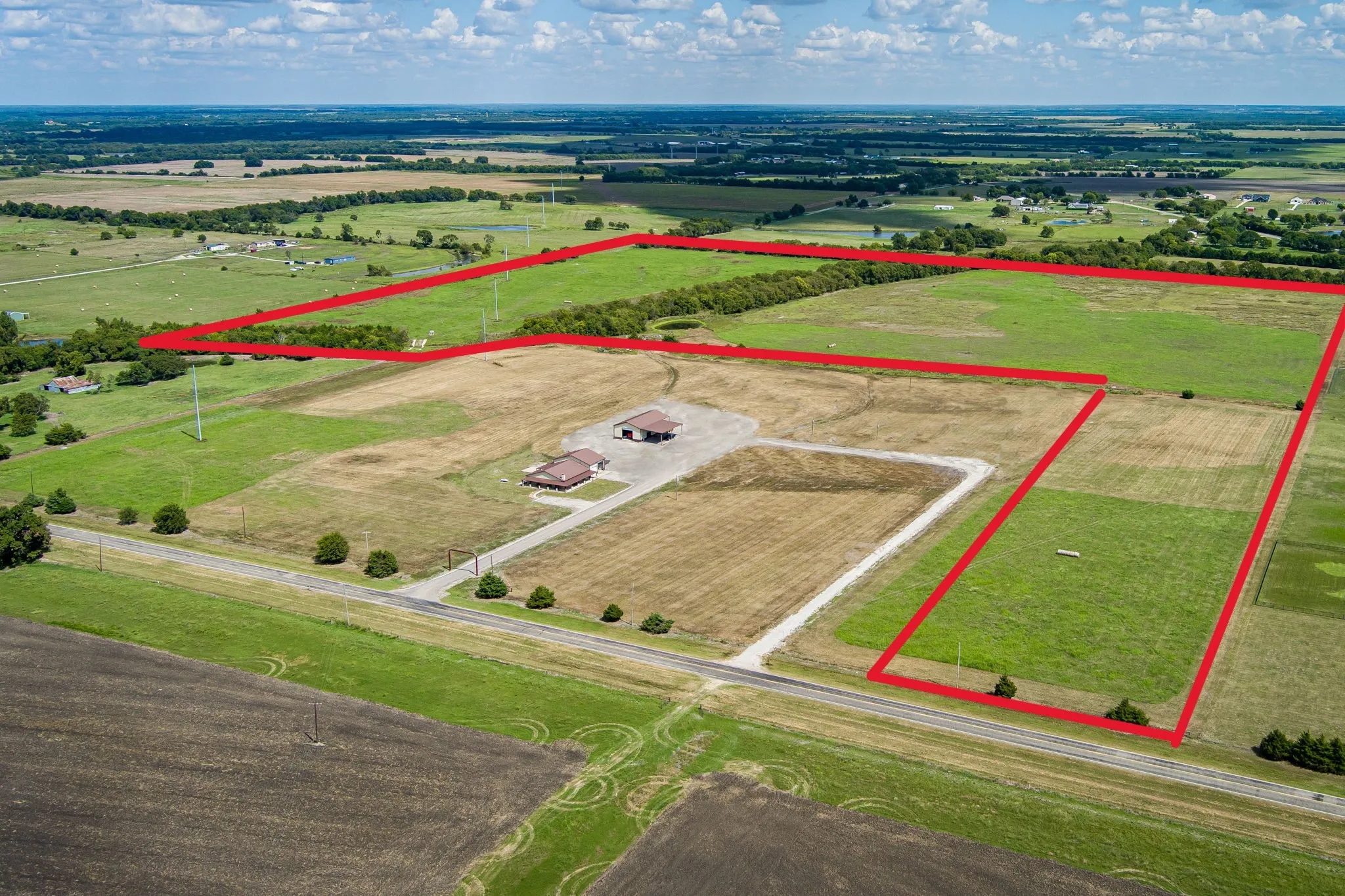 Expansive aerial view showcasing agricultural land with clearly defined property boundaries