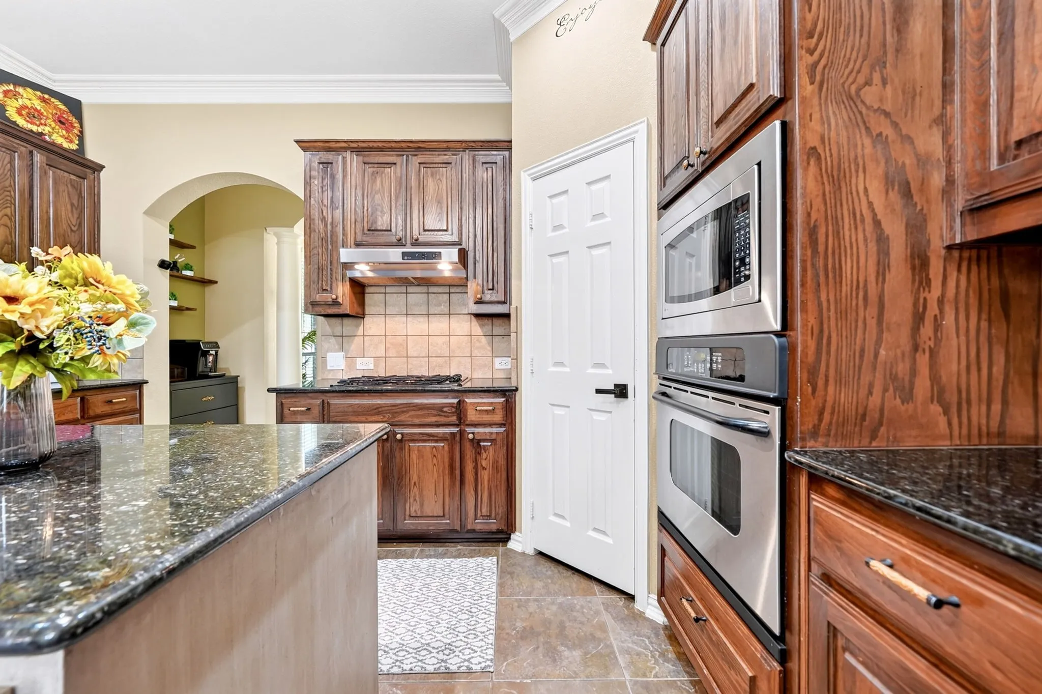 Kitchen featuring a built-in stainless steel microwave and oven combination
