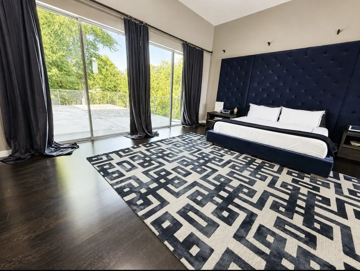 Dark wood-finish flooring with expansive floor-to-ceiling glass doors