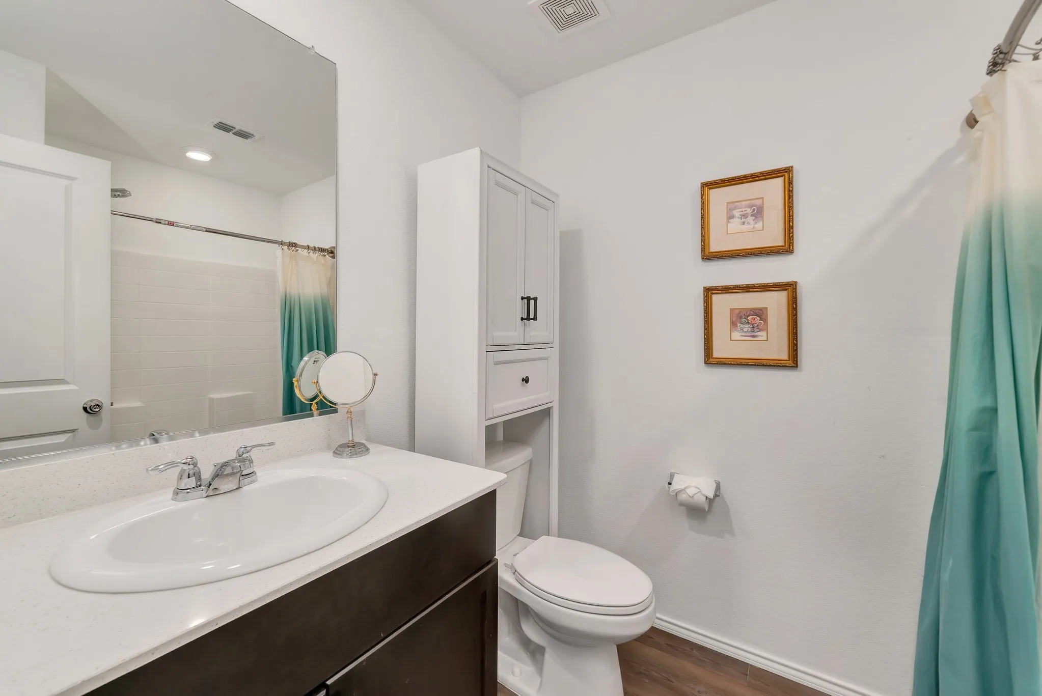 Bathroom vanity with a white countertop and oval undermount sink