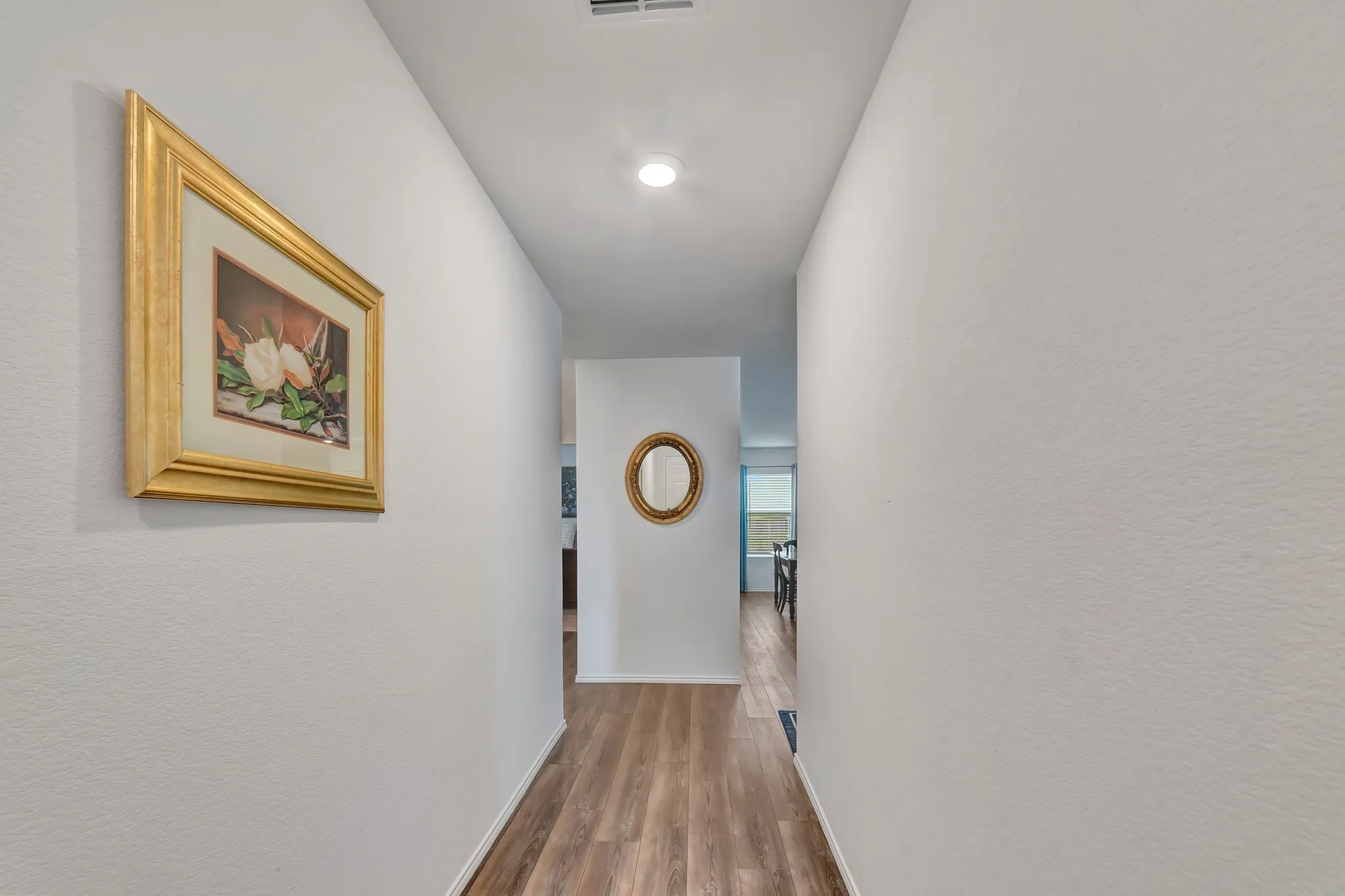 Hallway featuring wood-finish flooring, recessed lighting, and neutral wall tones