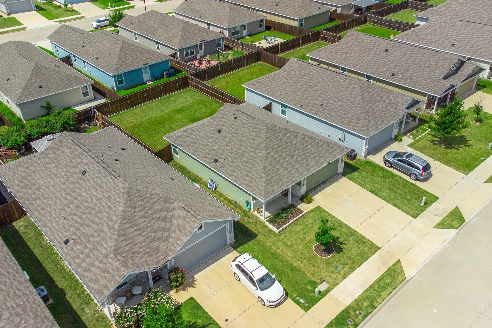 Aerial perspective highlighting residential properties with shingle roofing