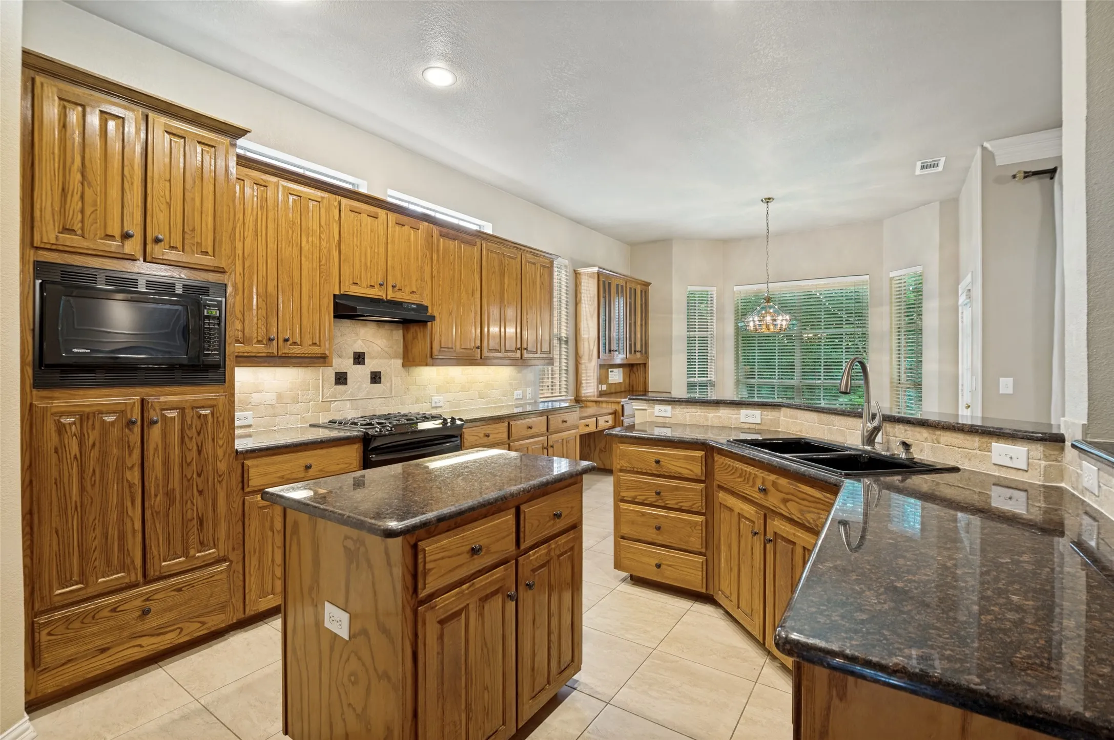 Custom cabinets, granite counter tops, dual sink and a gas stove is perfect for the chef.