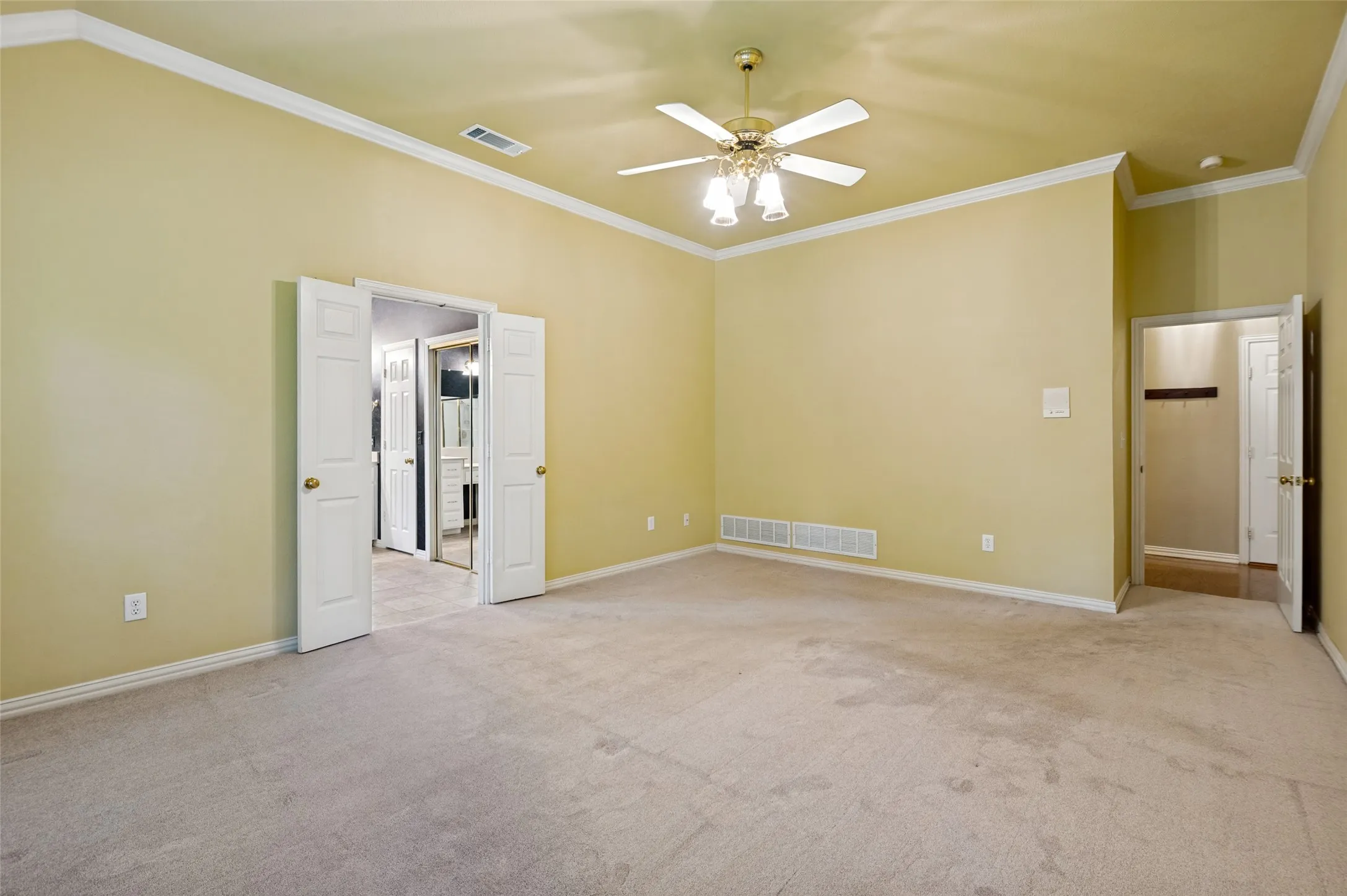 A private primary bedroom is secluded from the living areas and has access to the backyard.