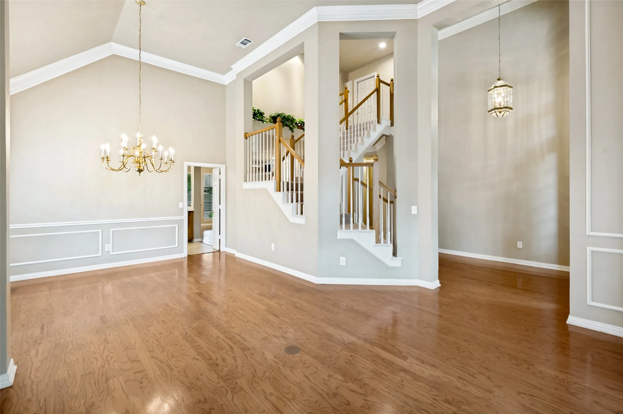 The expansive entry opens to the living and dining rooms with hardwood flooring and attention to designer details.