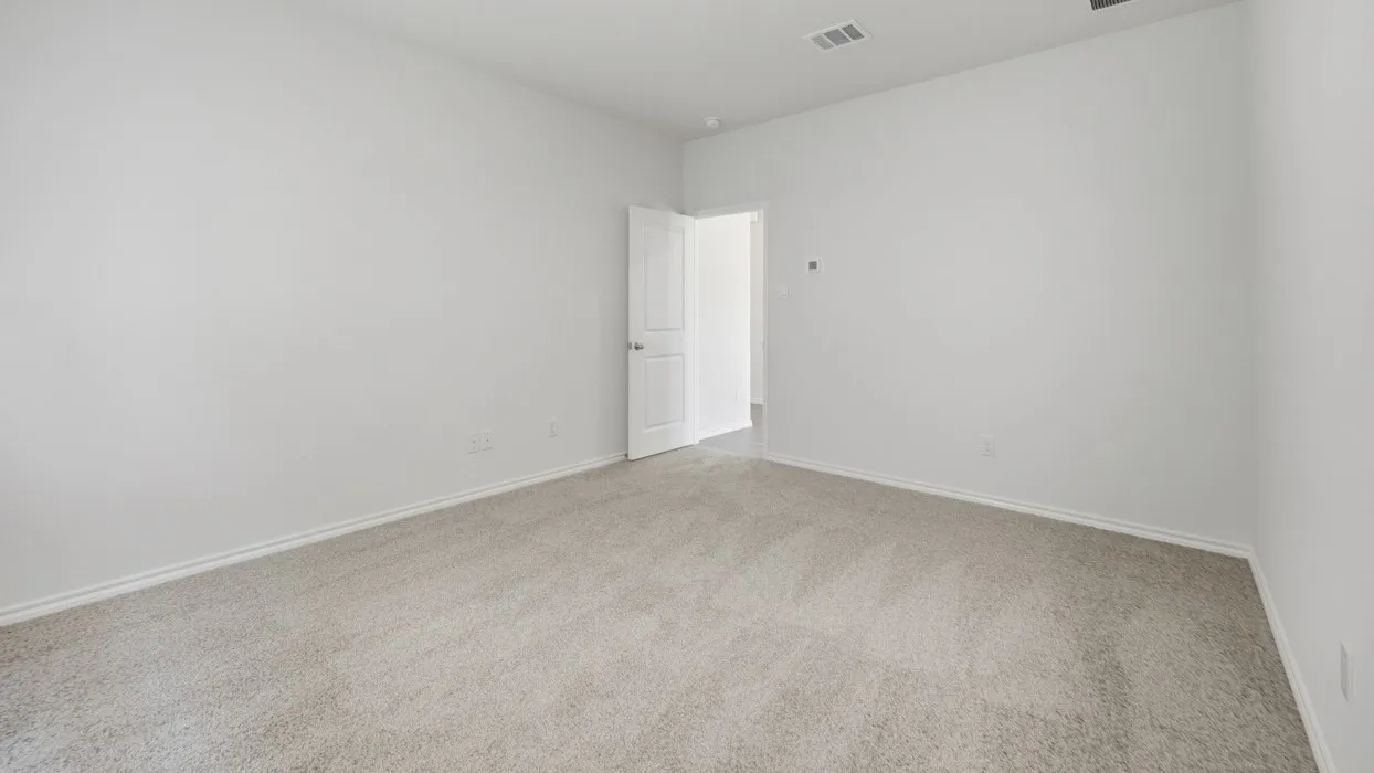 Spacious room featuring light gray carpet flooring, white painted walls, and white baseboards