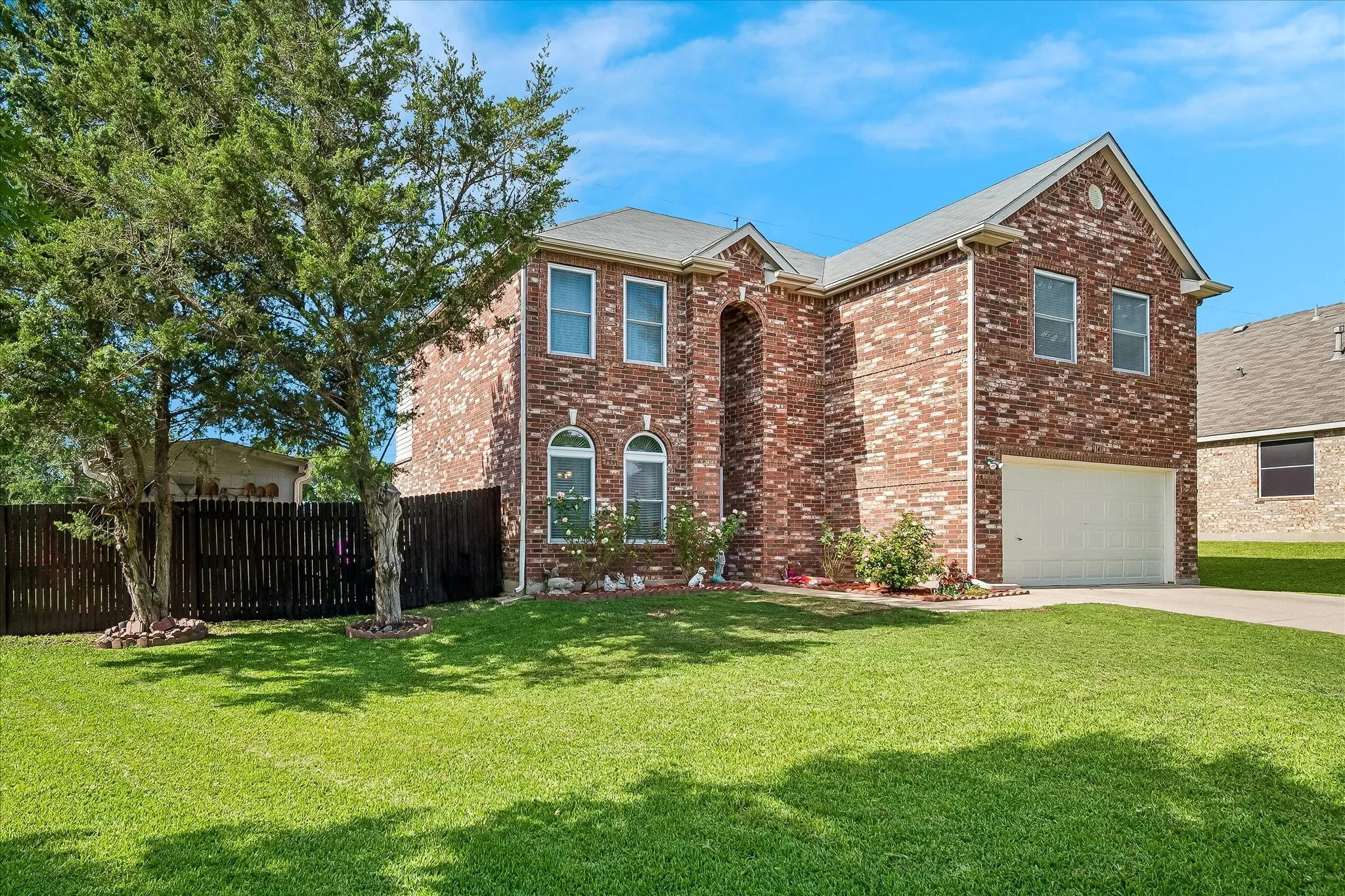 Brick-clad two-story exterior with an attached garage