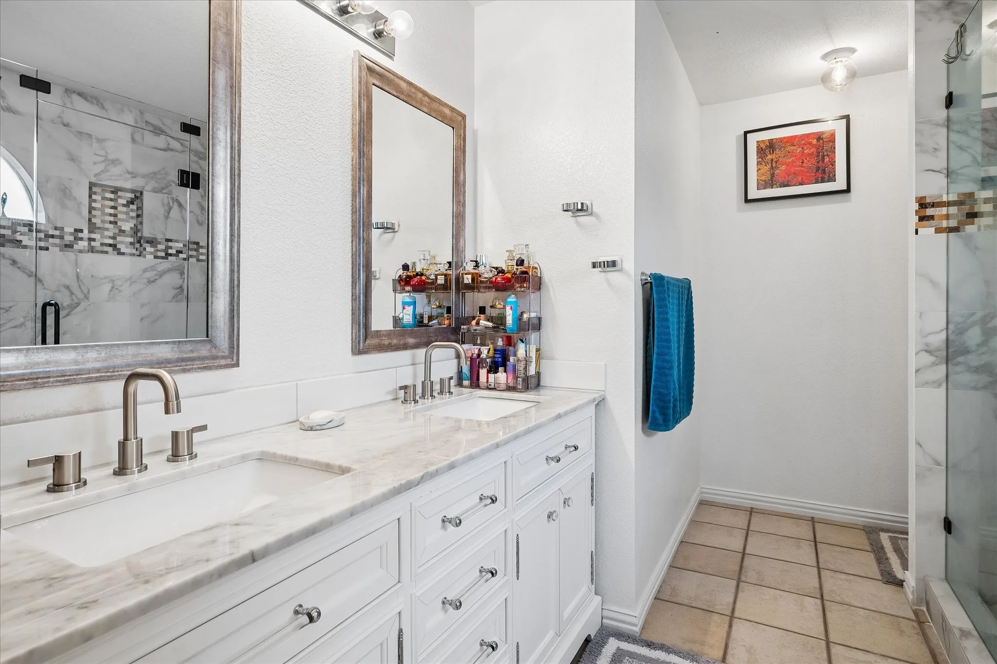 Double vanity with undermount sinks and light-toned stone countertops